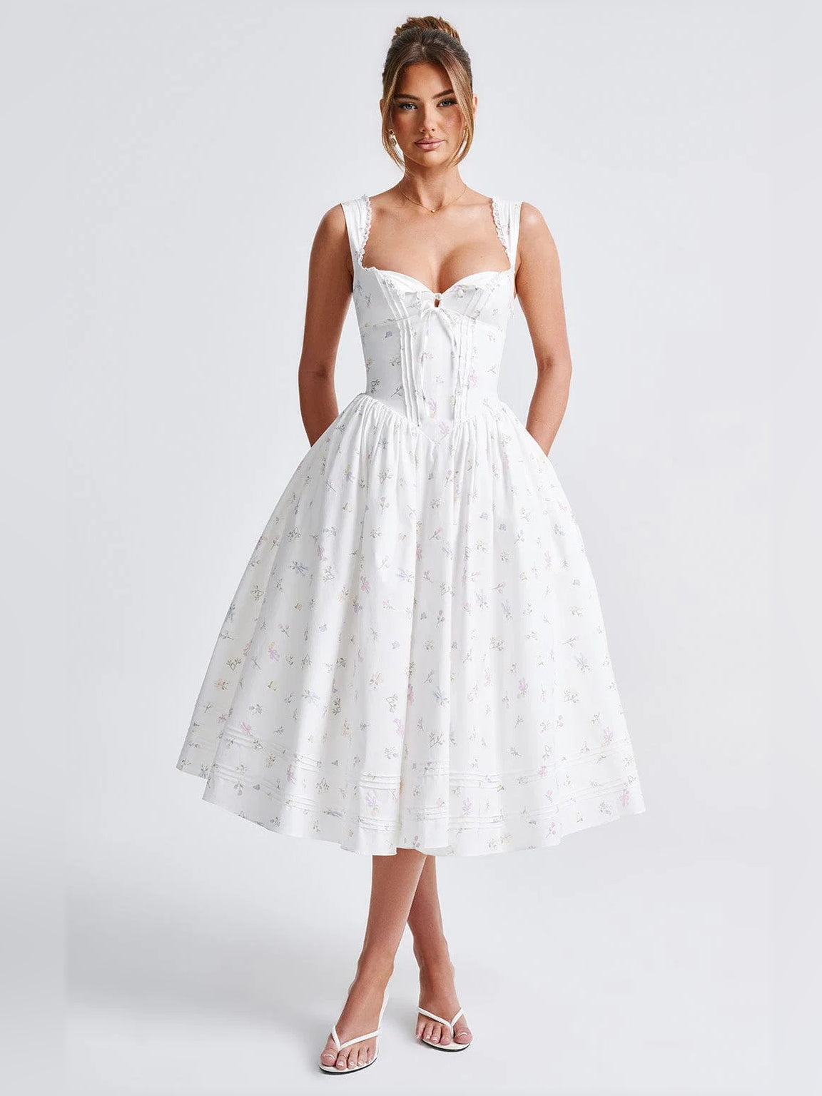 White midi formal dress with fitted corset bodice, lace-trim straps, pleated full skirt, printed