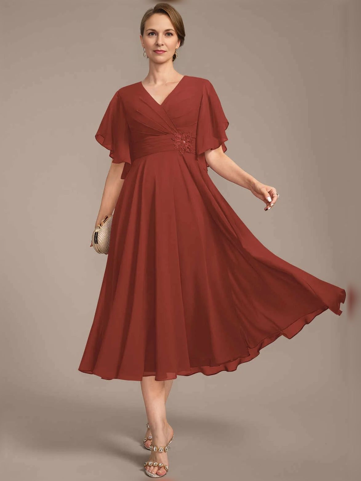 V-neck A-line chiffon dress with draped bodice, pleated skirt, flutter sleeves, rust red