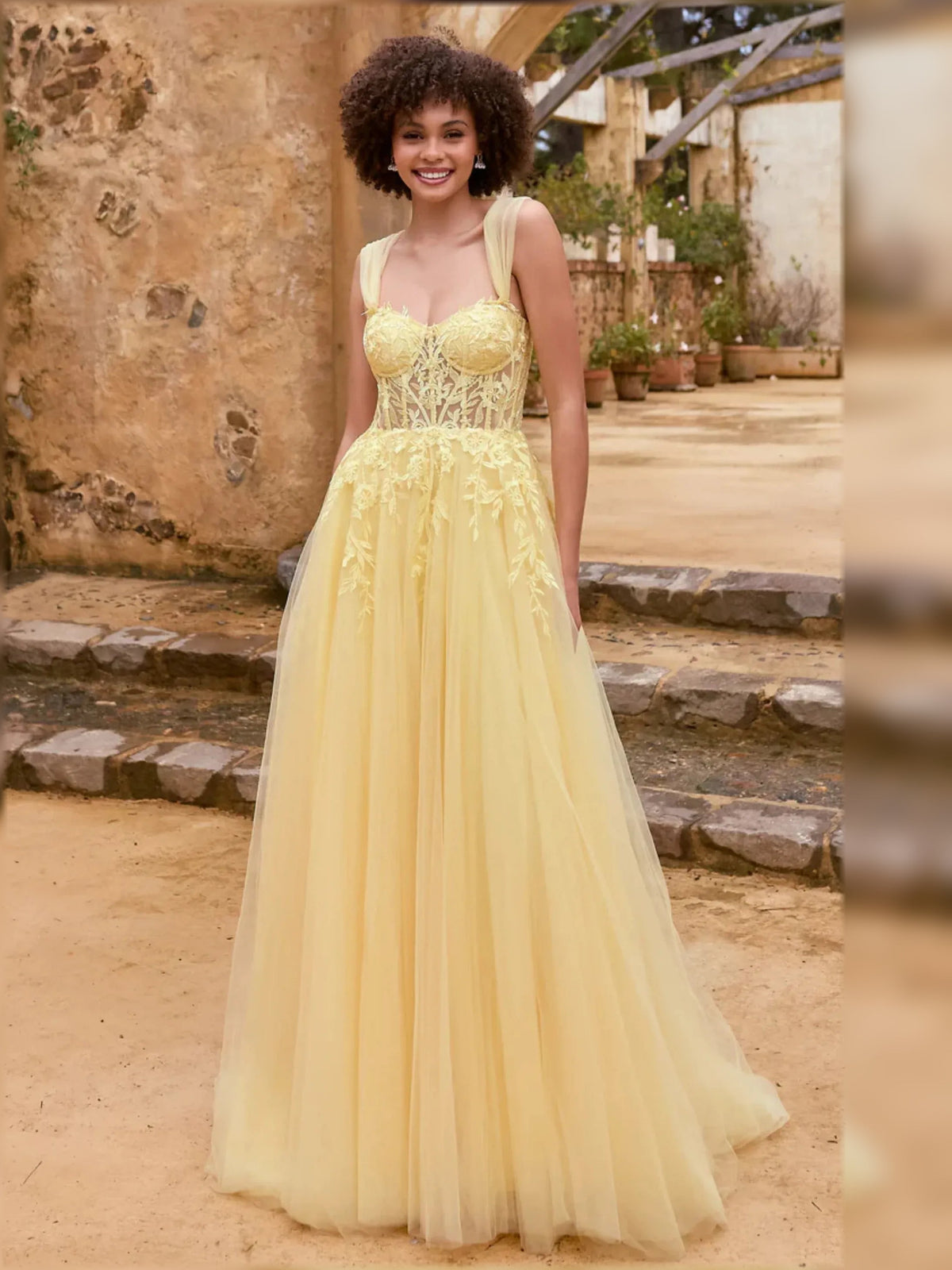Pale lemon off-the-shoulder maxi dress with lace bodice and layered tulle skirt