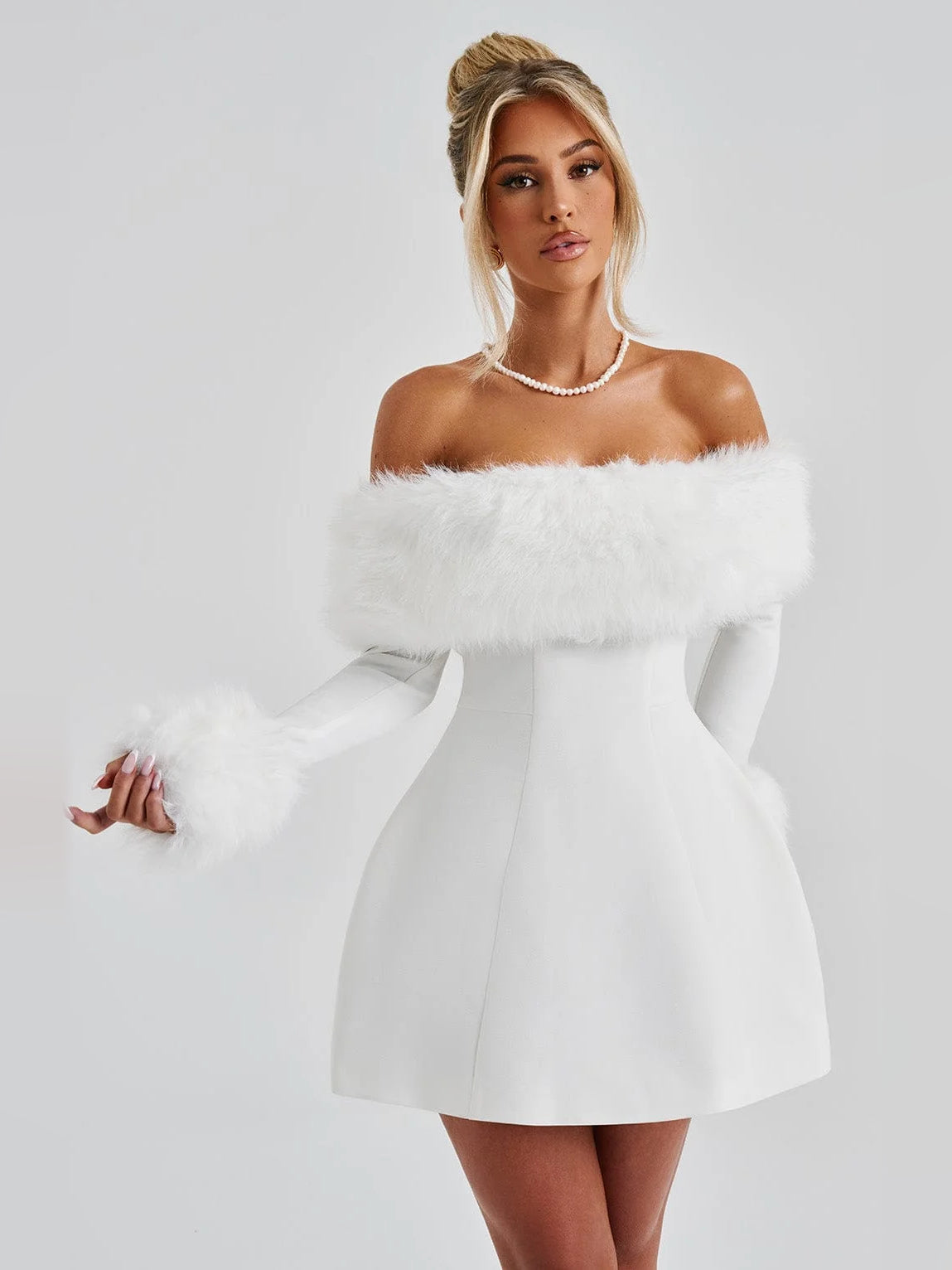 Ivory off-shoulder mini dress featuring faux fur trim across the shoulders.