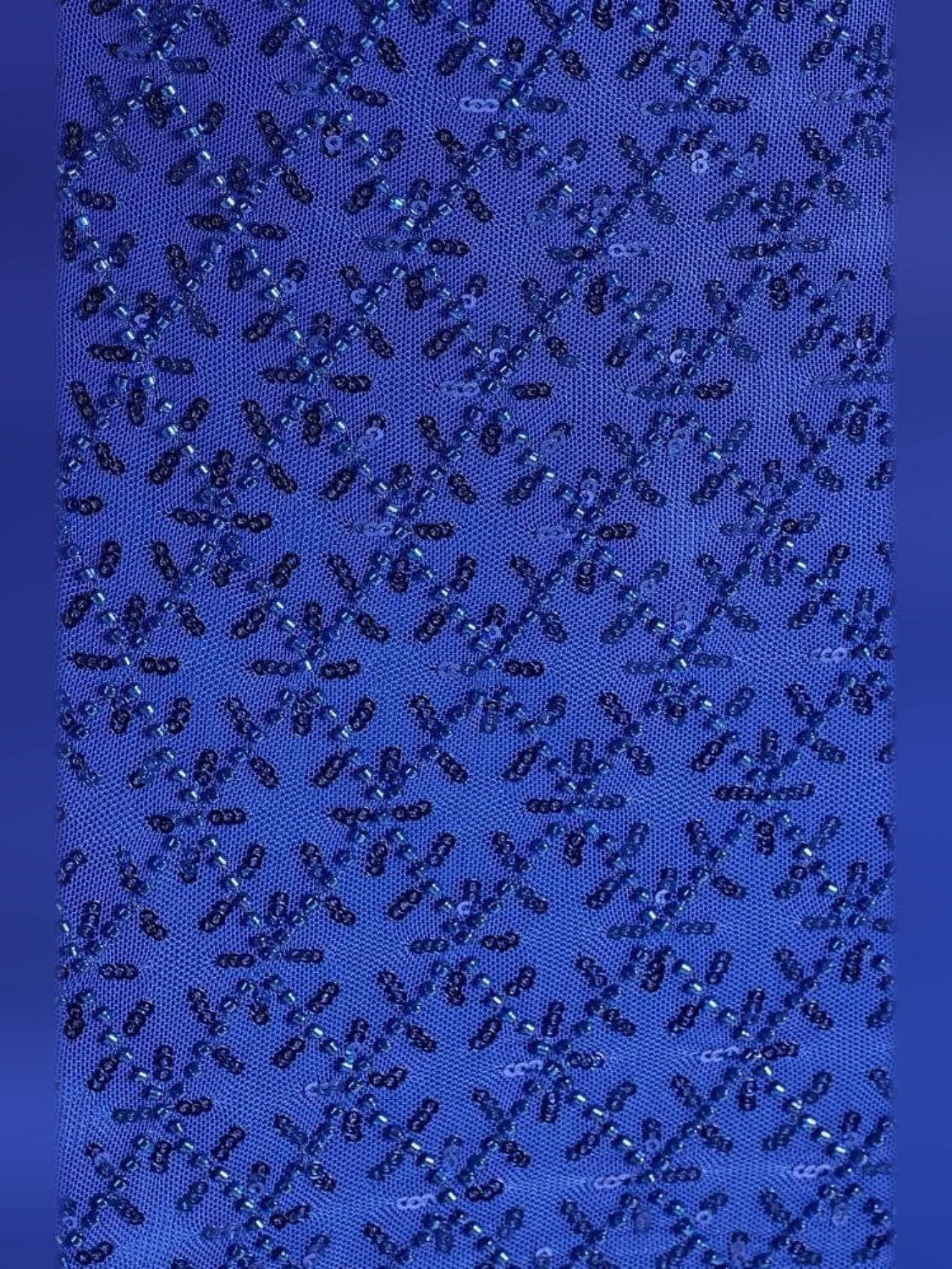 Blue beaded sequin fabric close-up with diamond-like pattern