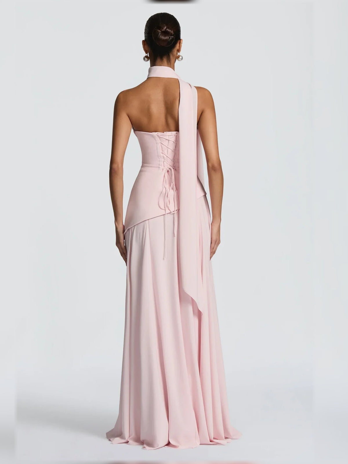 Blush pink strapless corset dress with lace-up back detailing and floor-length skirt