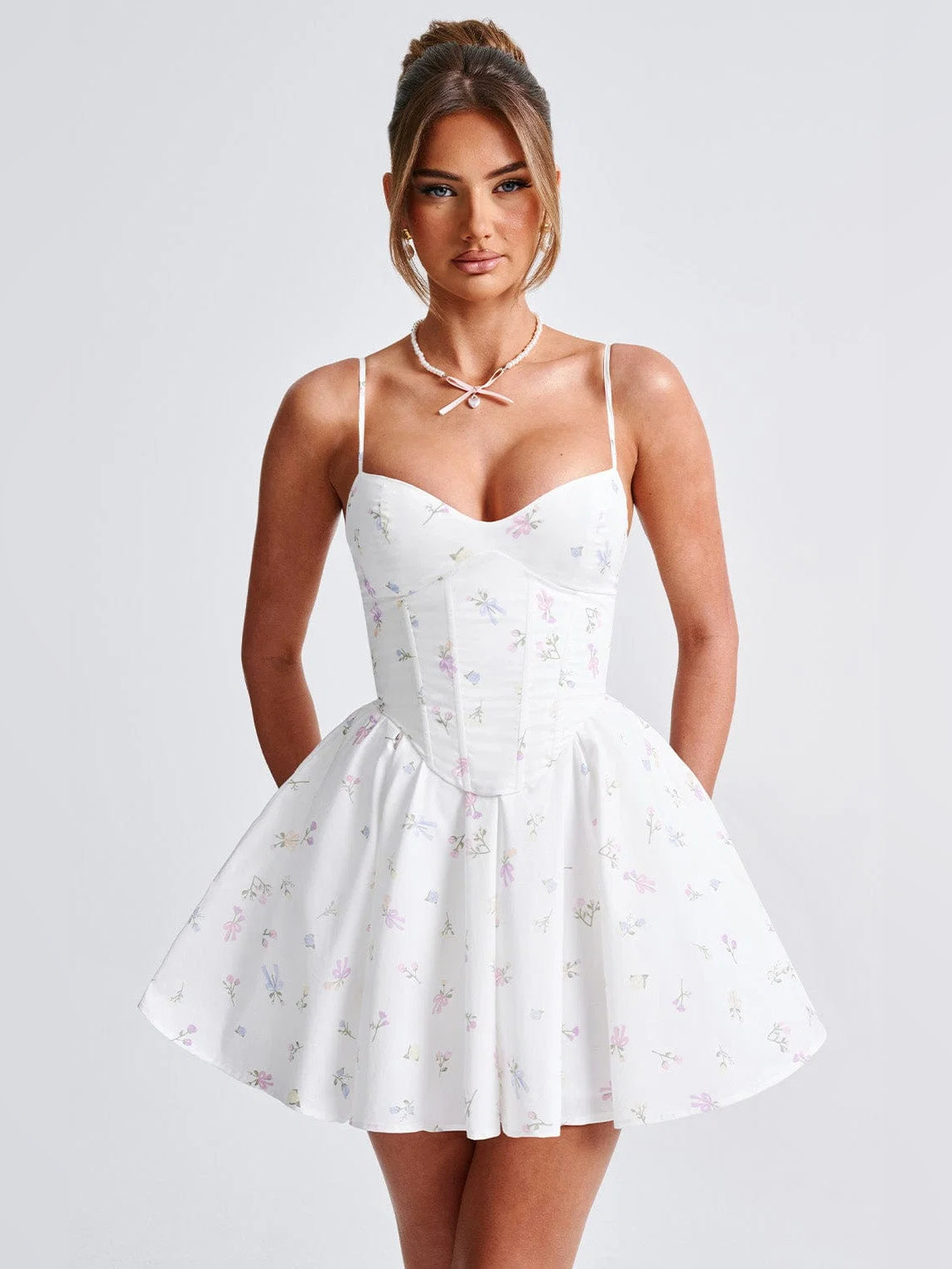 Floral mini homecoming dress with corset bodice, spaghetti straps, and A-line skirt