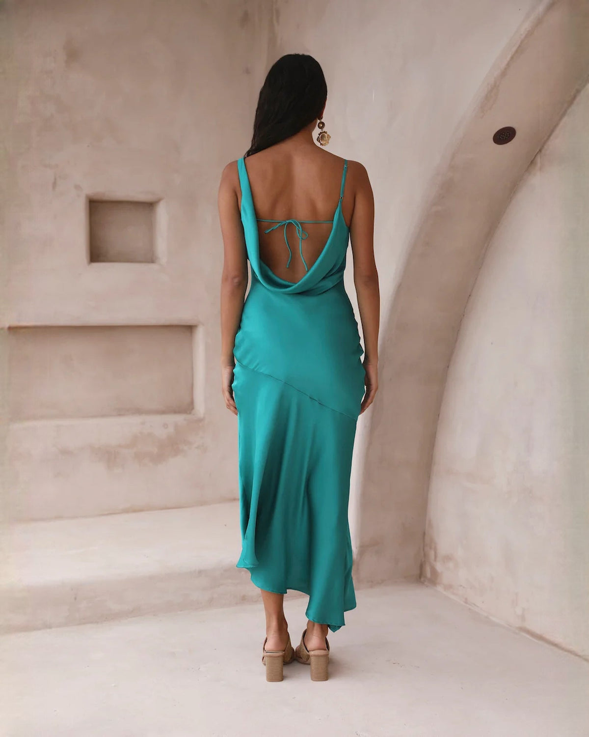 Teal satin sleeveless A-line midi dress with lace-up open back and side slit.