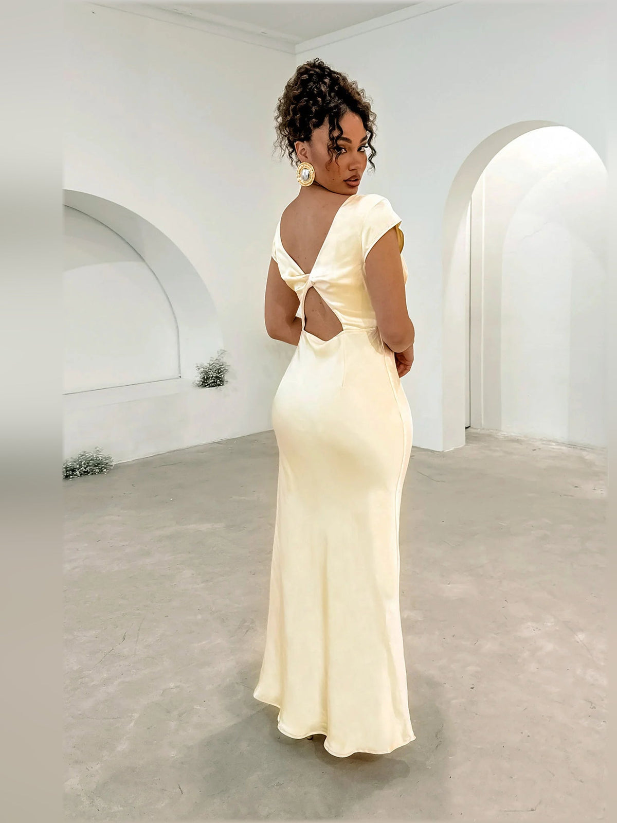 Yellow midi dress rear view with open back and twisted detail