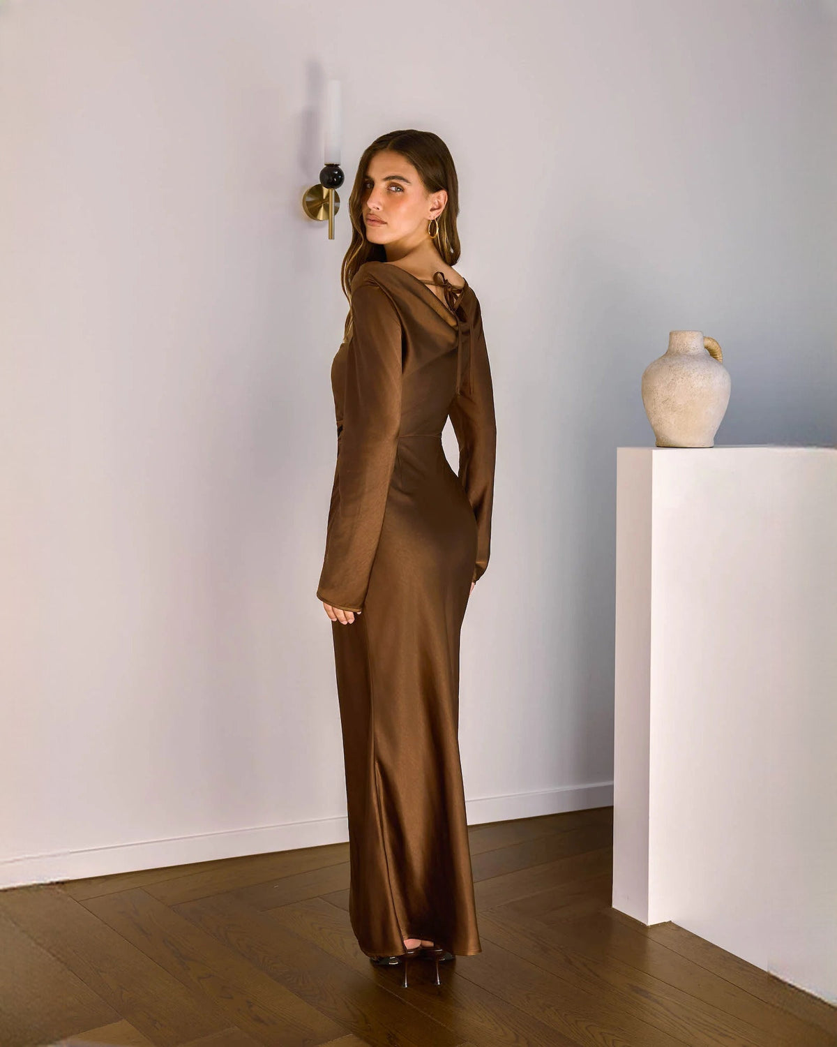 Chocolate brown satin maxi dress with long sleeves and back view showing draped seam lines