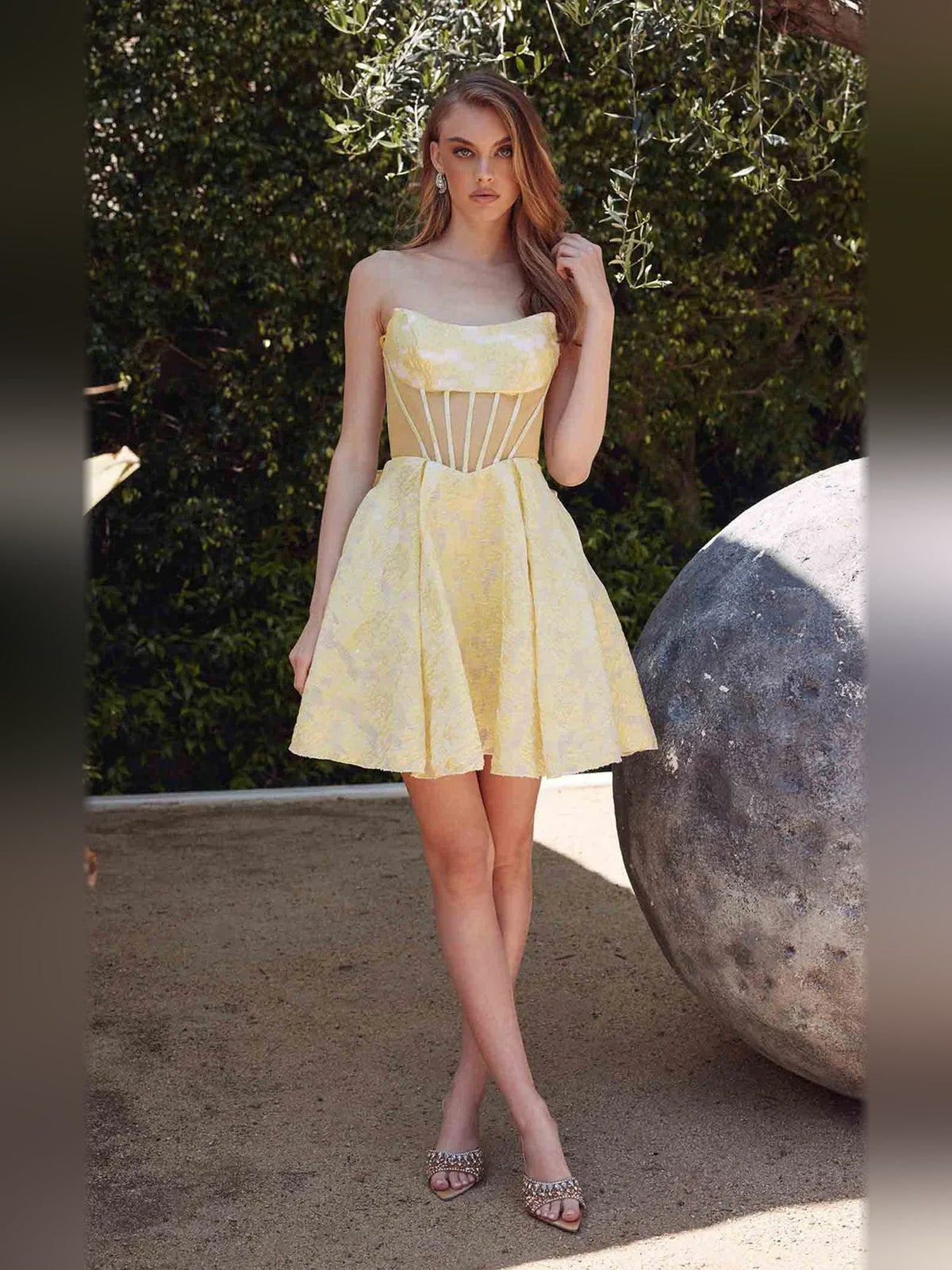 Pale lemon strapless corset A-line short dress outdoors with flared skirt and ruffle top