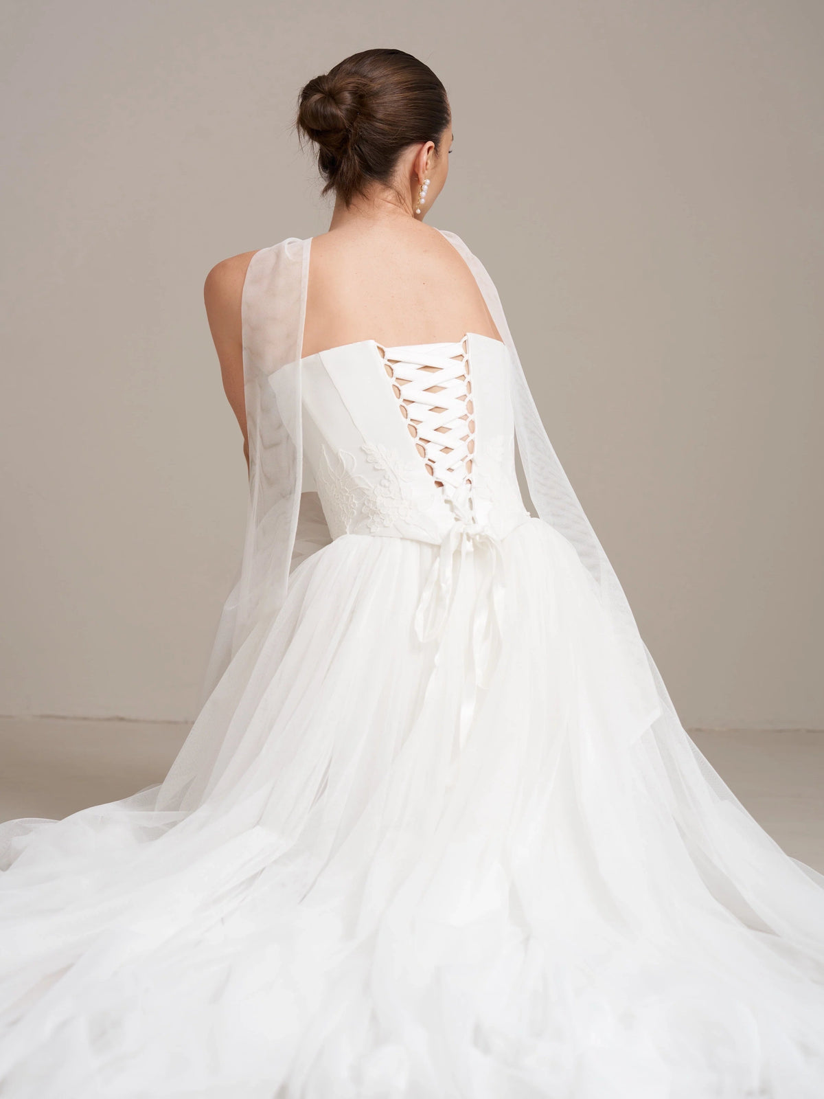 Ivory corset wedding dress with lace-up back and long flowing tulle train