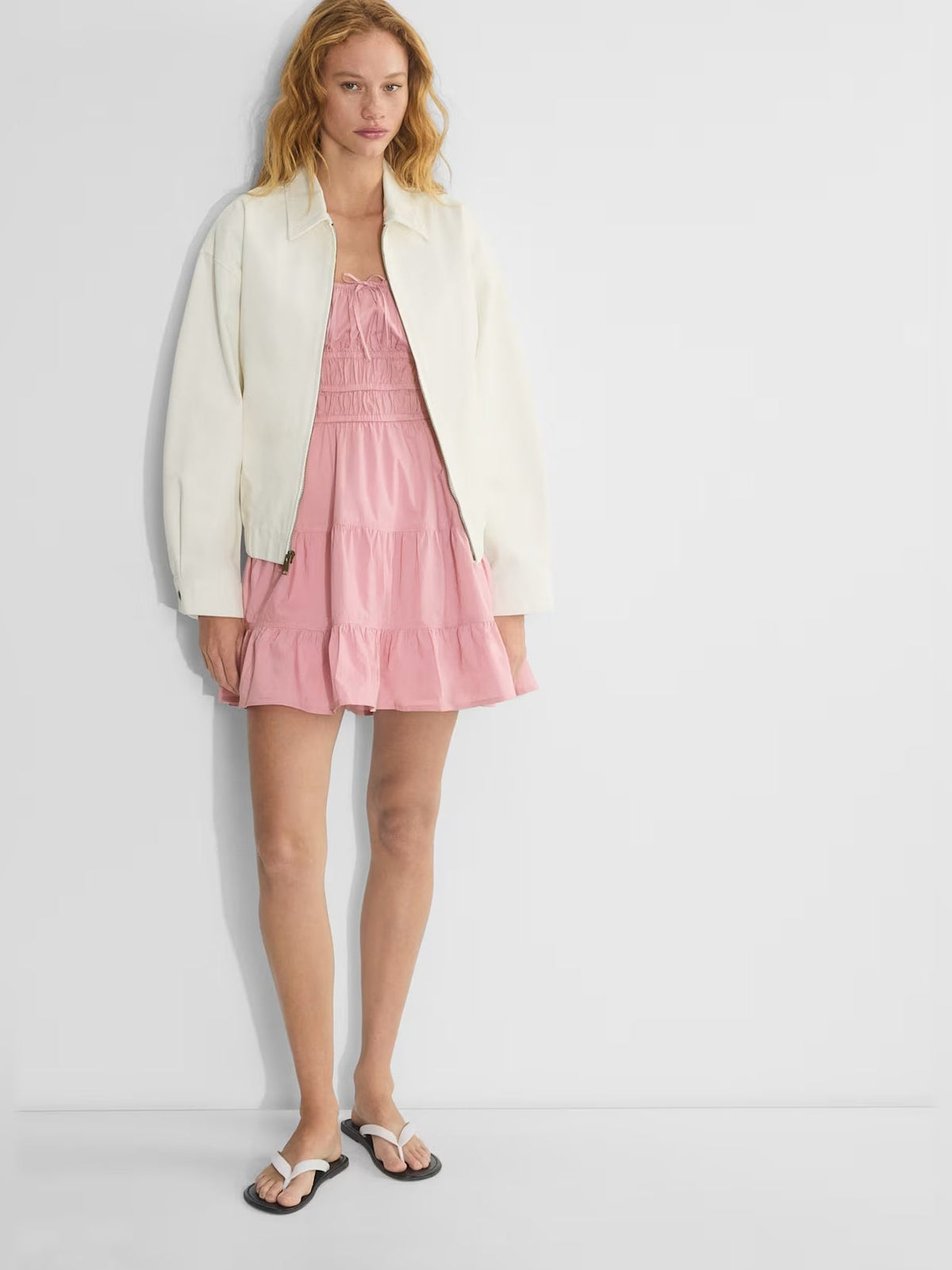Pink tiered mini dress with thin straps and gathered skirt