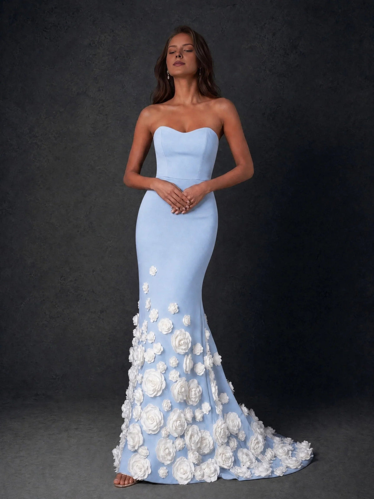 Light blue strapless formal gown with sweetheart neckline and white rose appliques at hem