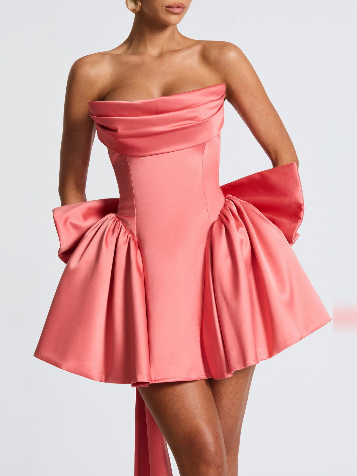 Pink strapless mini dress with draped neckline and gathered skirt with puffy sides