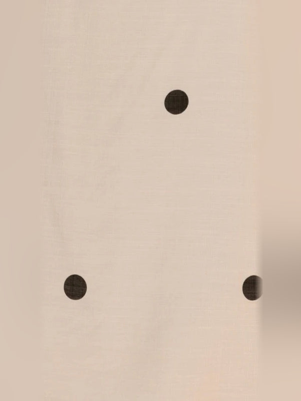 Cream fabric with scattered black polka dots