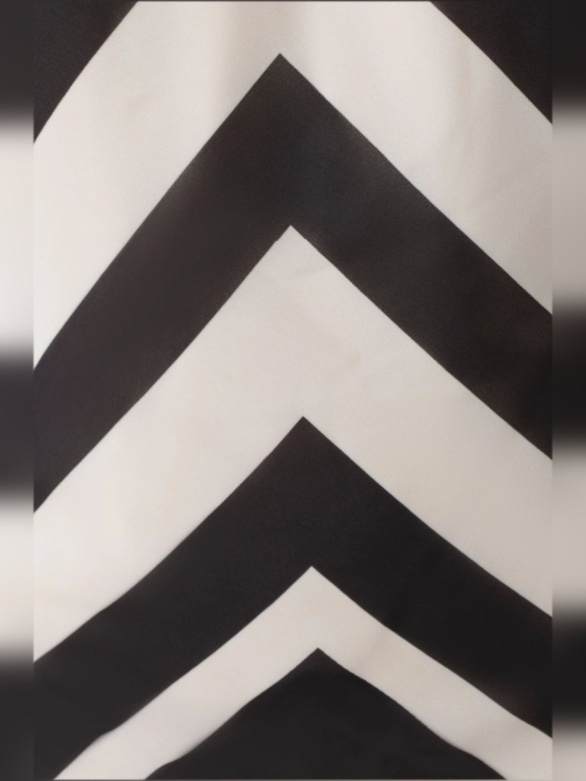 Close-up of black-and-white chevron zigzag fabric pattern on satin.