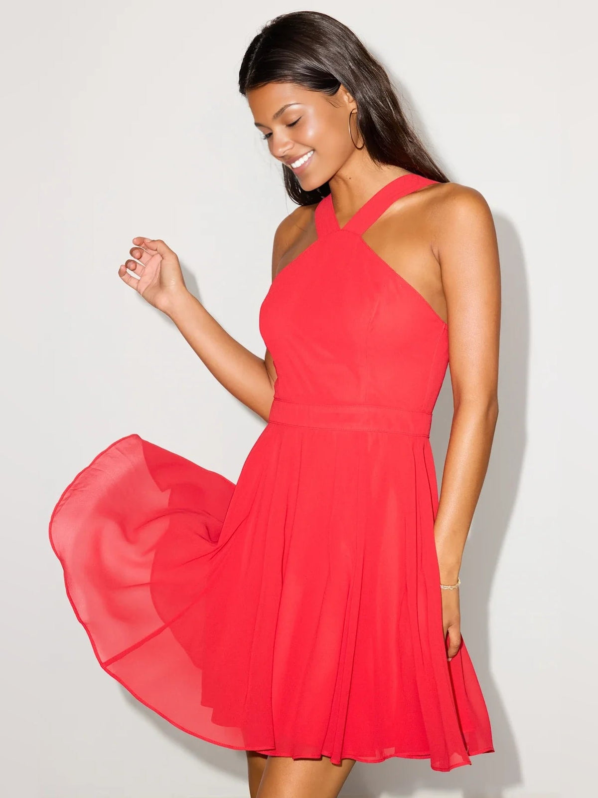 Red halter neck mini dress with cross halter back and flared pleated skirt