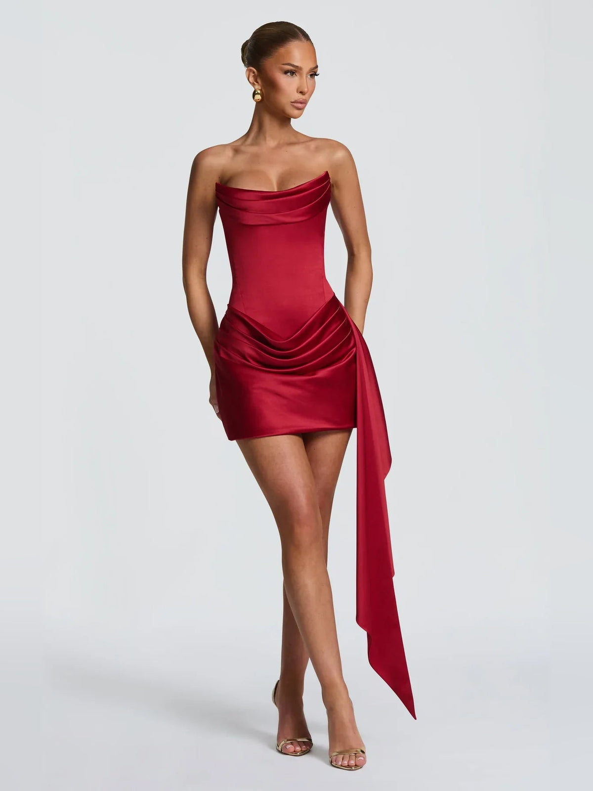 Deep red strapless satin bodycon mini dress with draped corset bodice and side sash