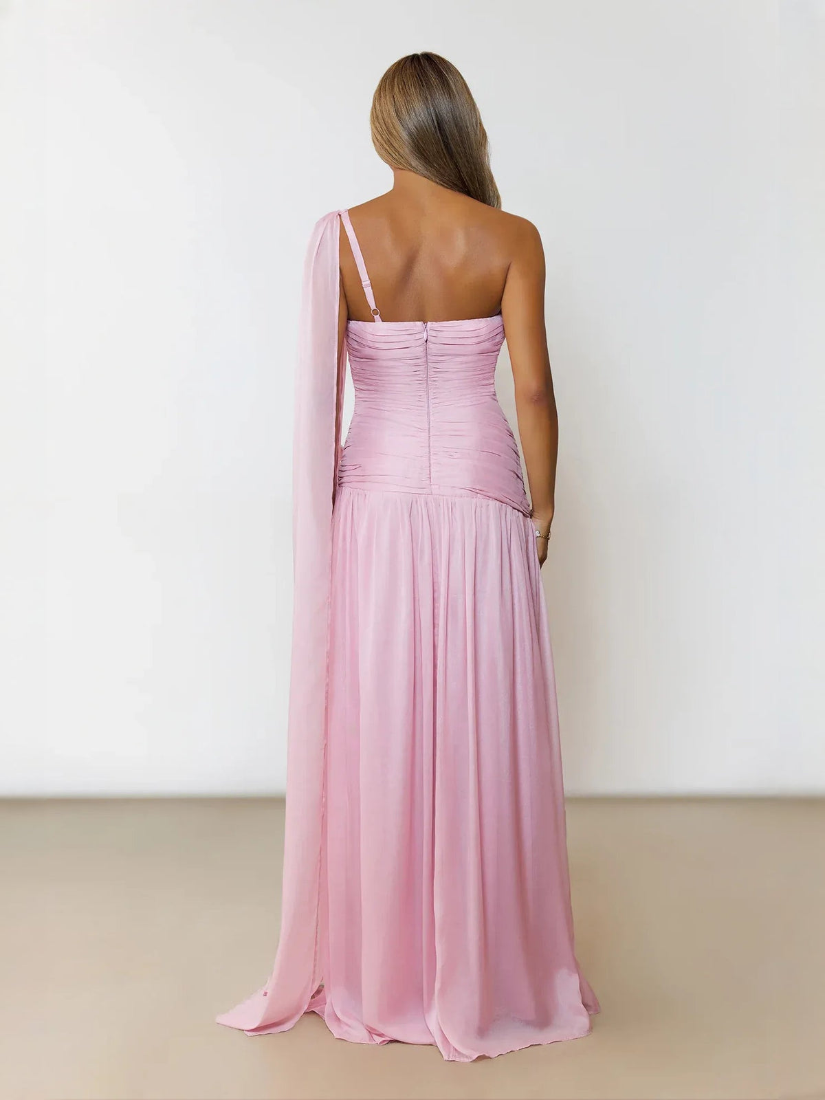 Pink ruched one-shoulder maxi dress with back drape, gathered bodice, and flowing skirt