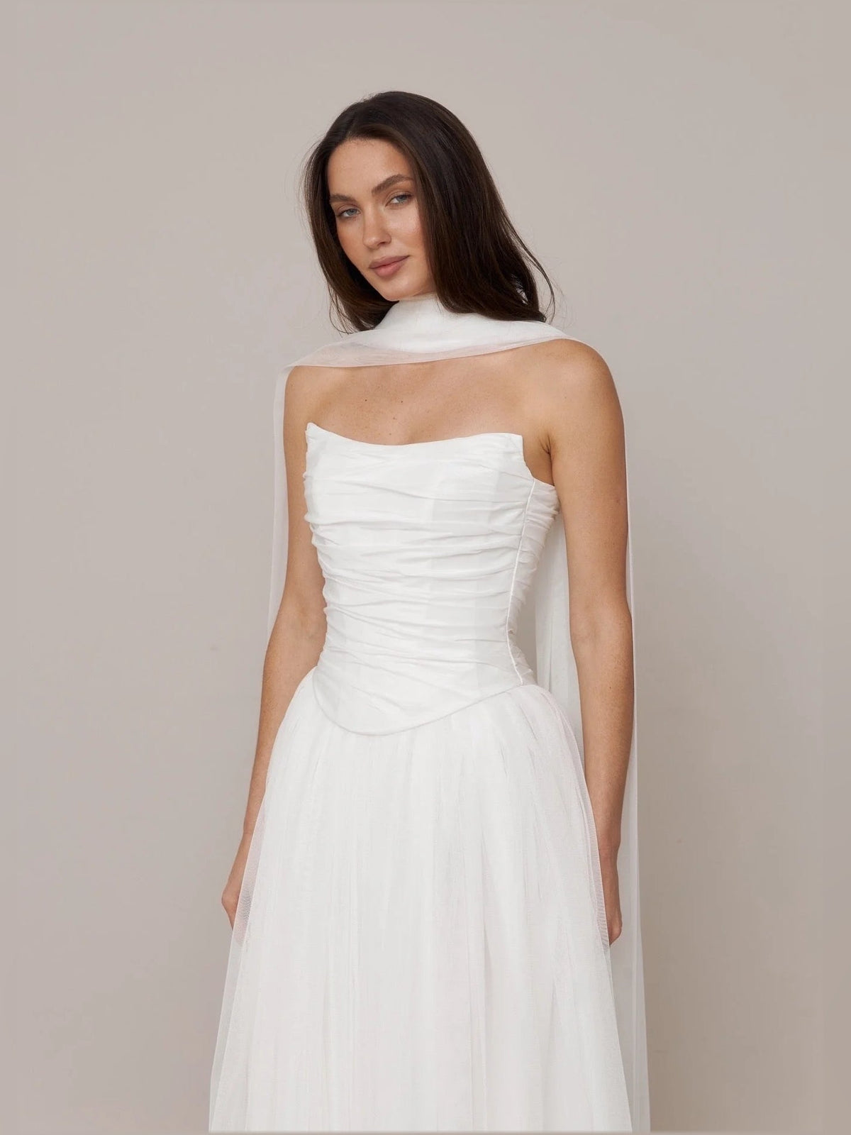 Ivory strapless wedding dress with ruched bodice and gathered A-line skirt, front view