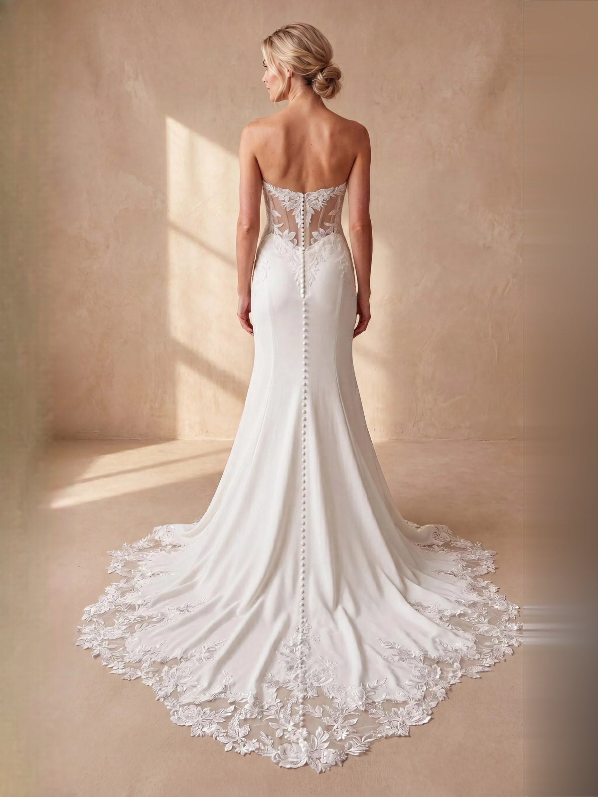 Ivory strapless mermaid wedding dress with lace corset back and long lace-trimmed train