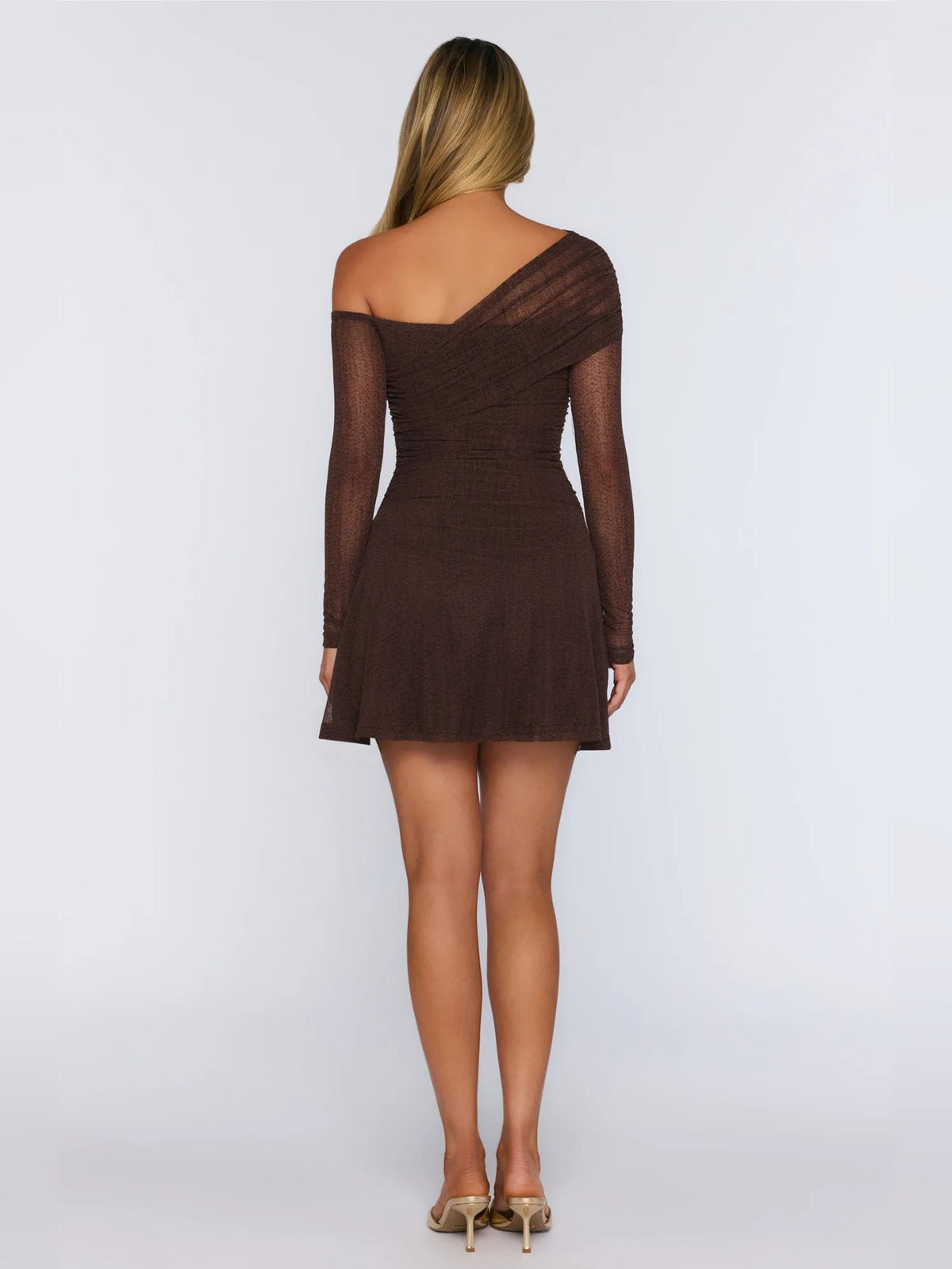Brown mini dress with open back, sheer long sleeves, and flared skirt; back view.