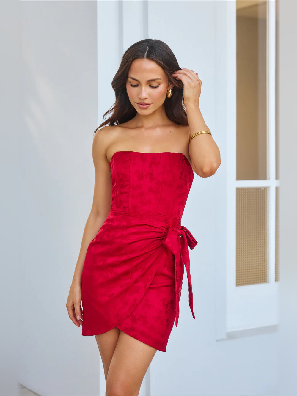 Red strapless mini homecoming dress with ruched front and side bow