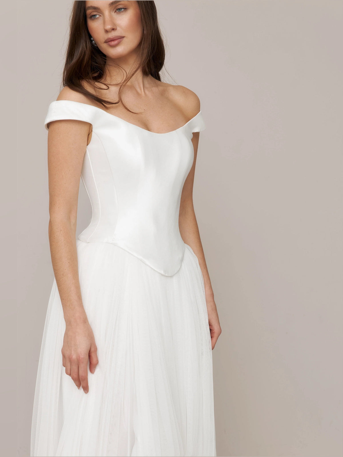 Ivory off-shoulder satin corset wedding dress with draped bodice and layered skirt