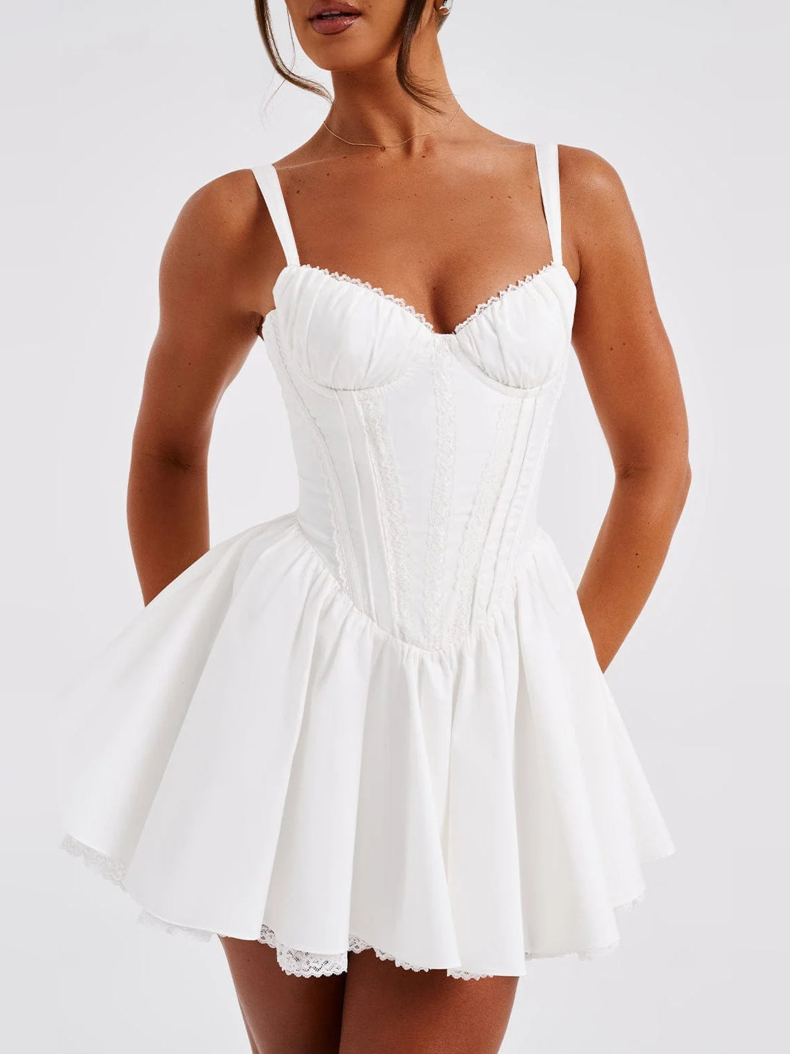 White mini dress with thin straps, sweetheart neckline, gathered waist, tiered skirt