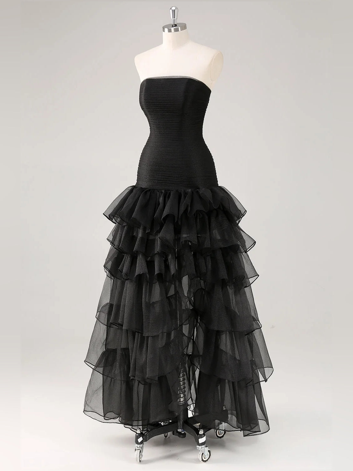 Black strapless dress on mannequin with ruched bodice and tiered ruffle skirt
