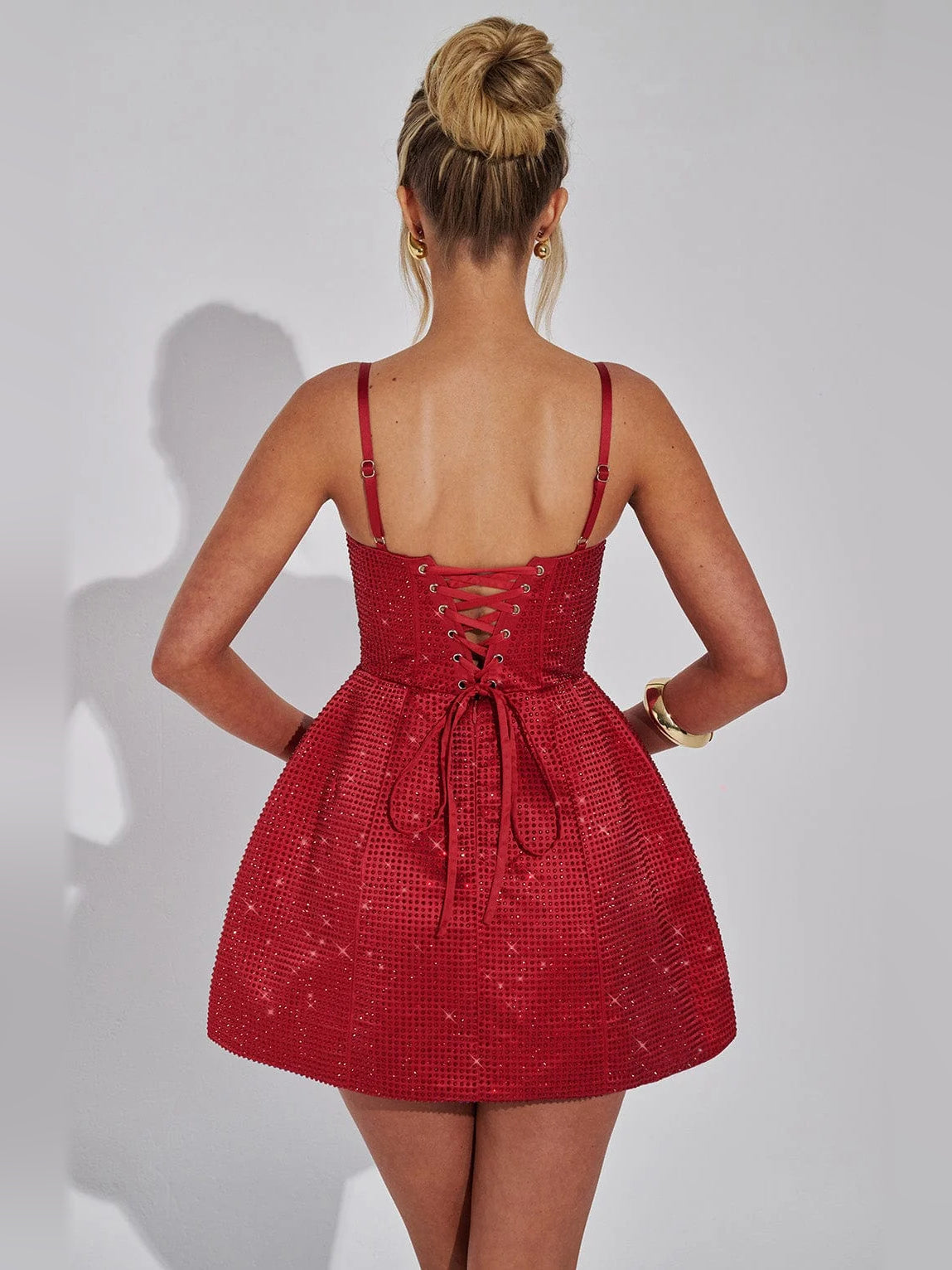 Red mini dress back view with lace-up crisscross detail and thin spaghetti straps