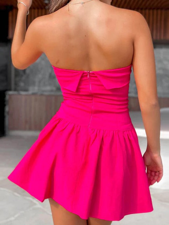 Back view of hot pink off-shoulder strapless mini dress with ruched bodice and flared skirt
