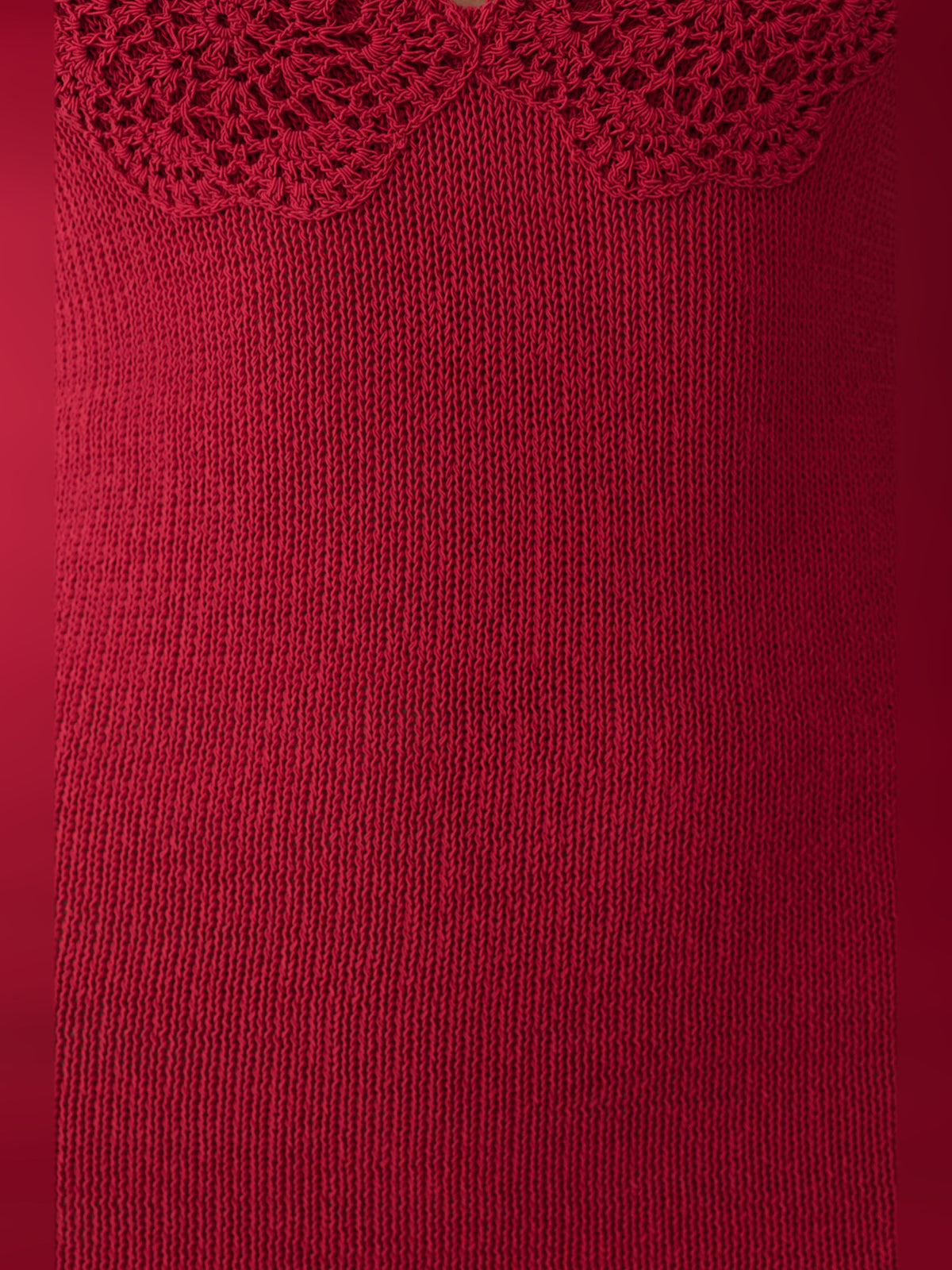 Close-up of pomegranate knit fabric with lace trim at the halter neckline