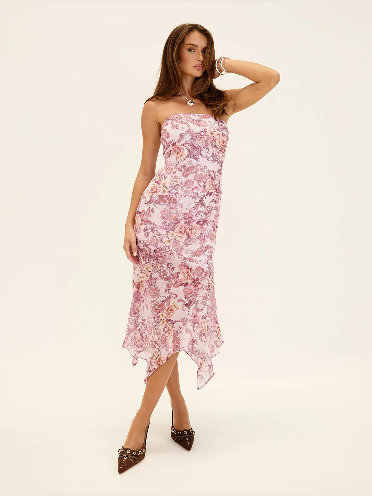 Pink paisley strapless asymmetrical midi dress with sweetheart neckline and high-low hem.