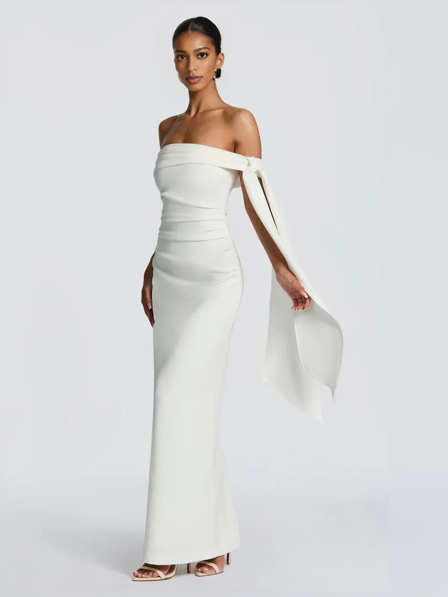 White off-shoulder sheath maxi dress with bow-tie drape at shoulder