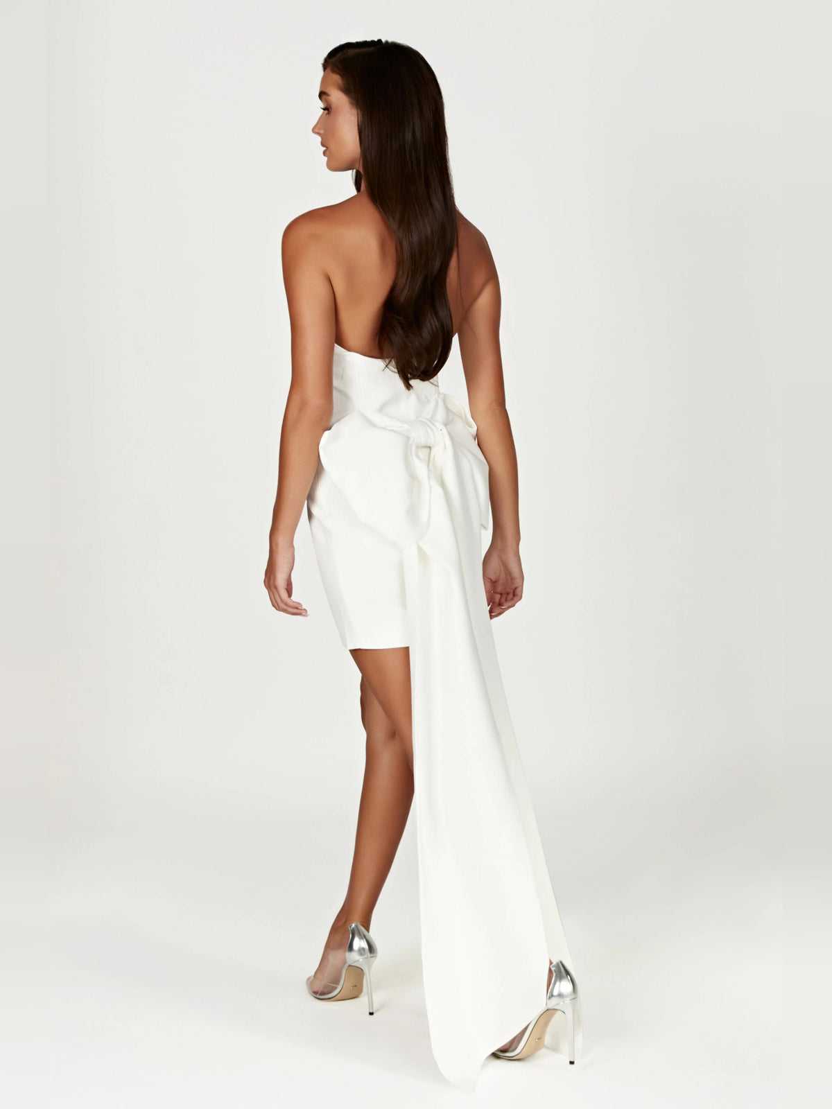 White strapless mini dress with long bow-back sash and open back