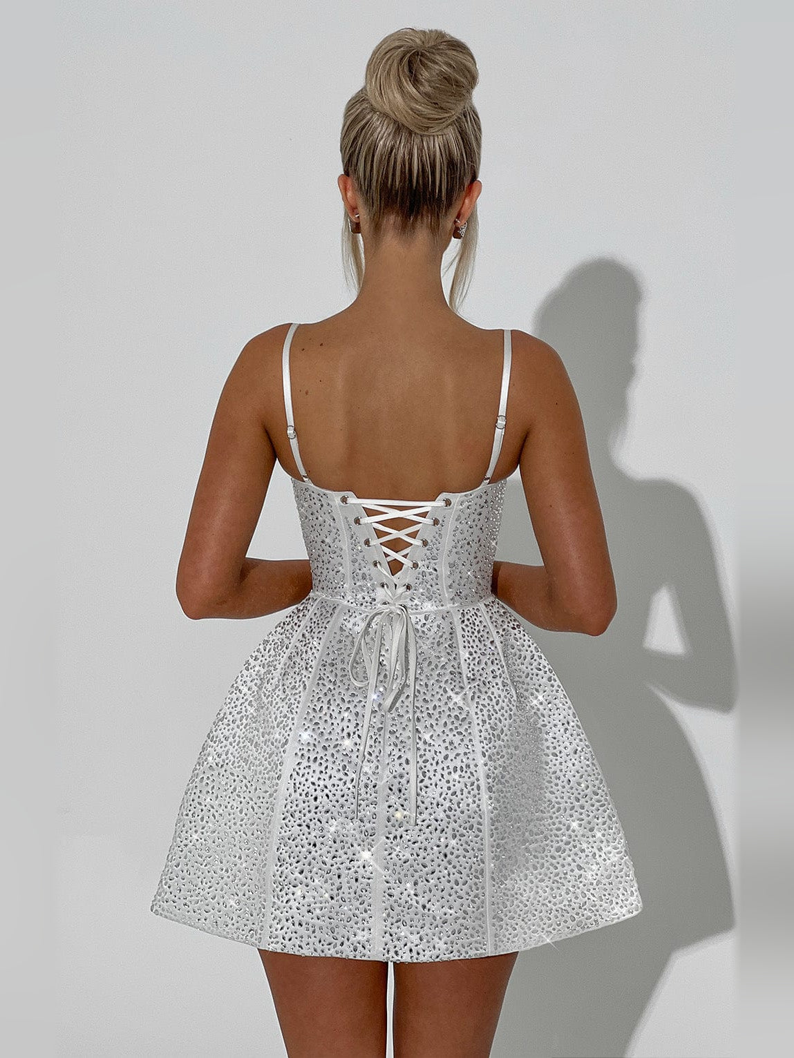 White sequin mini dress back with lace-up corset detail and spaghetti straps