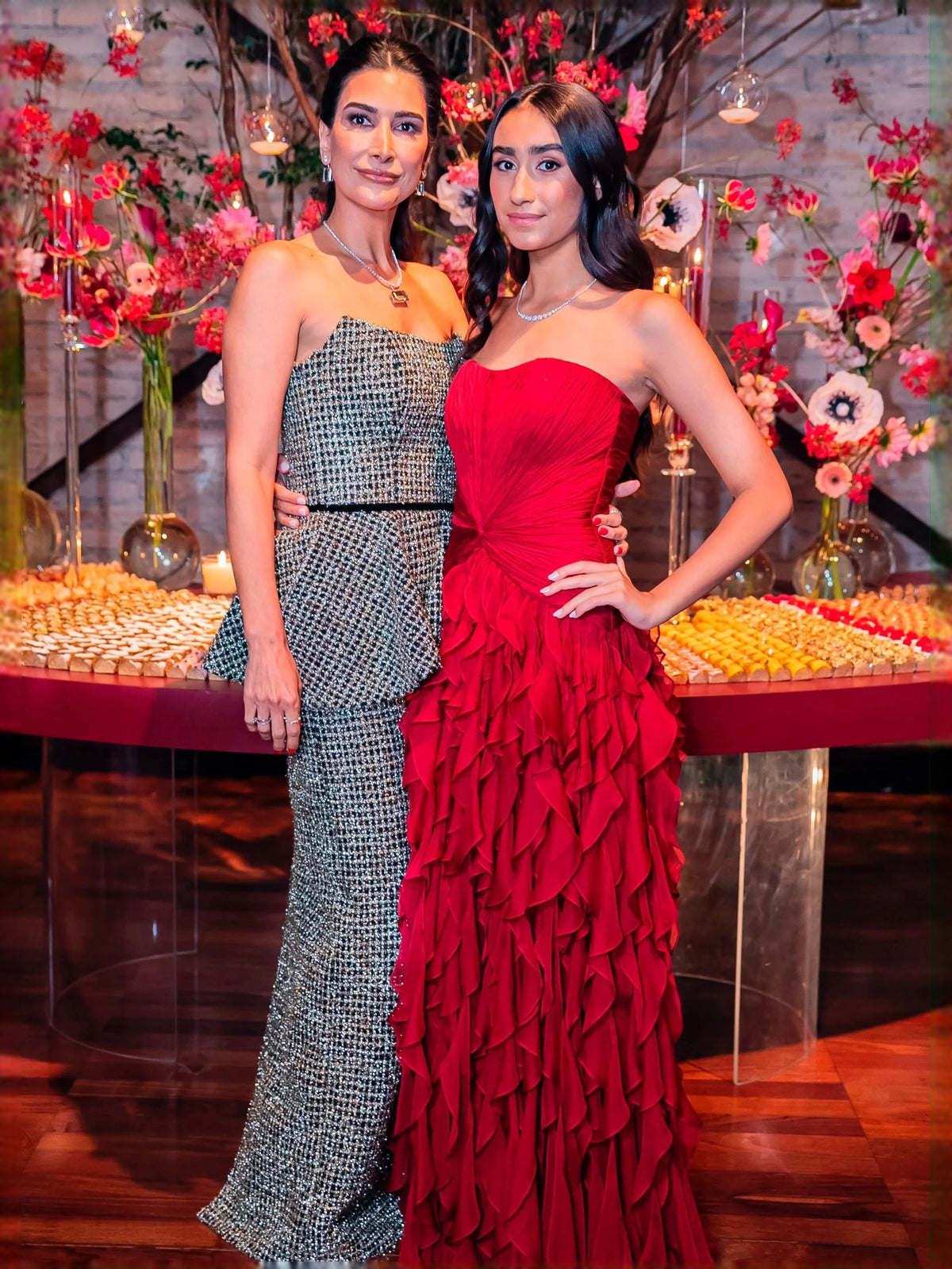 Red strapless sweetheart ball gown with ruched bodice and layered ruffle skirt, standing