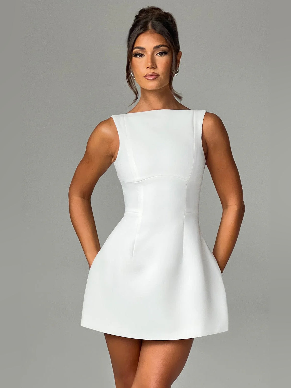 Ivory mini sleeveless dress with tailored seams and flared A-line hem