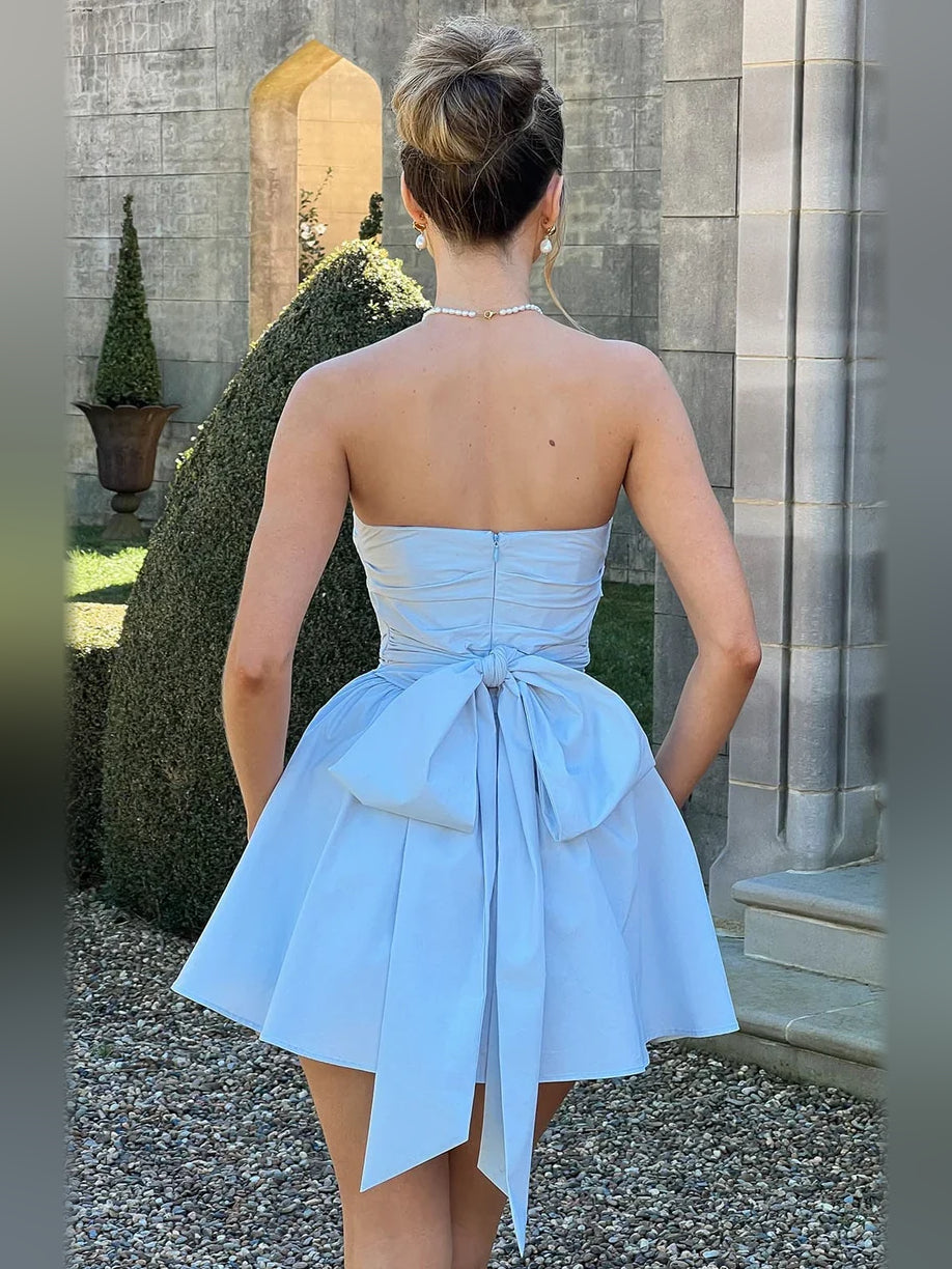 Light blue strapless mini A-line dress with ruched back and tied bow detail.