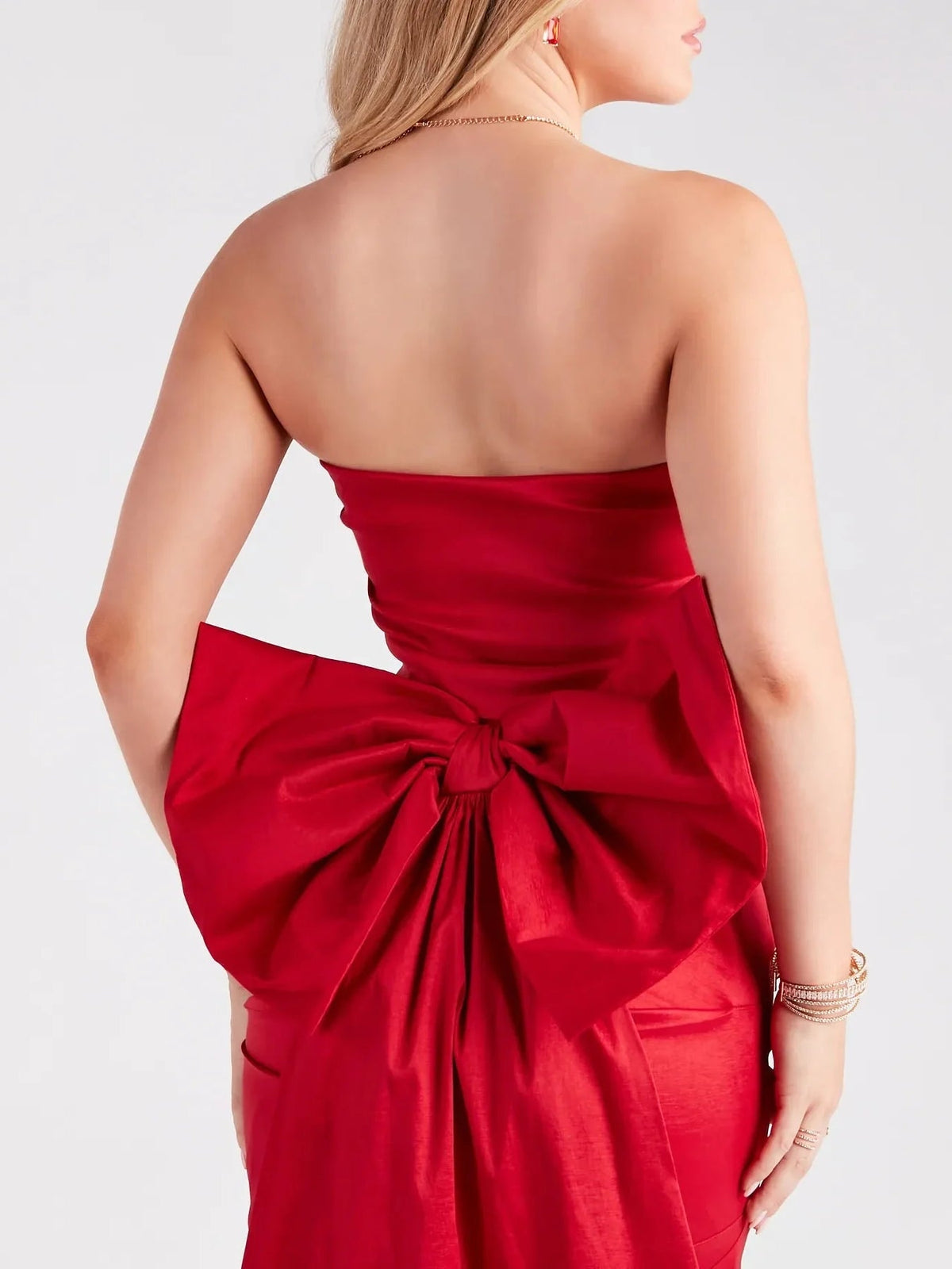 Red satin strapless mini dress with draped back bow and ruched waist