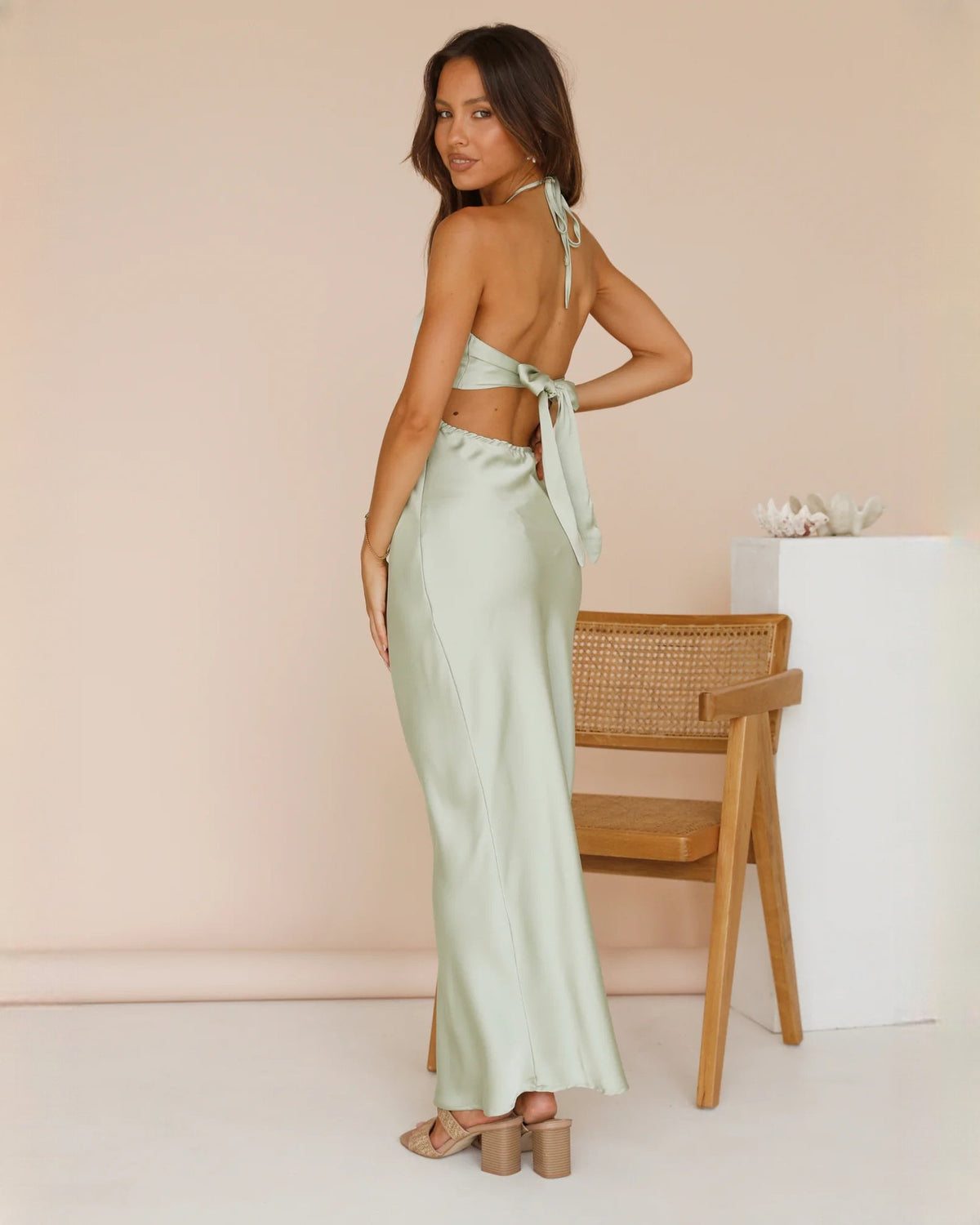 Mint green satin halter maxi dress from side view with tie back drape