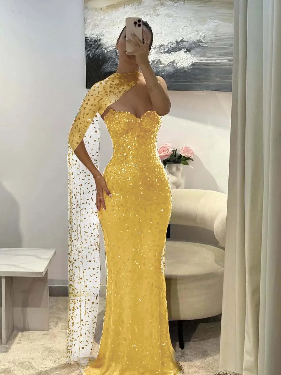 Gold sequin sweetheart mermaid prom dress with long sheer side drape, floor-length