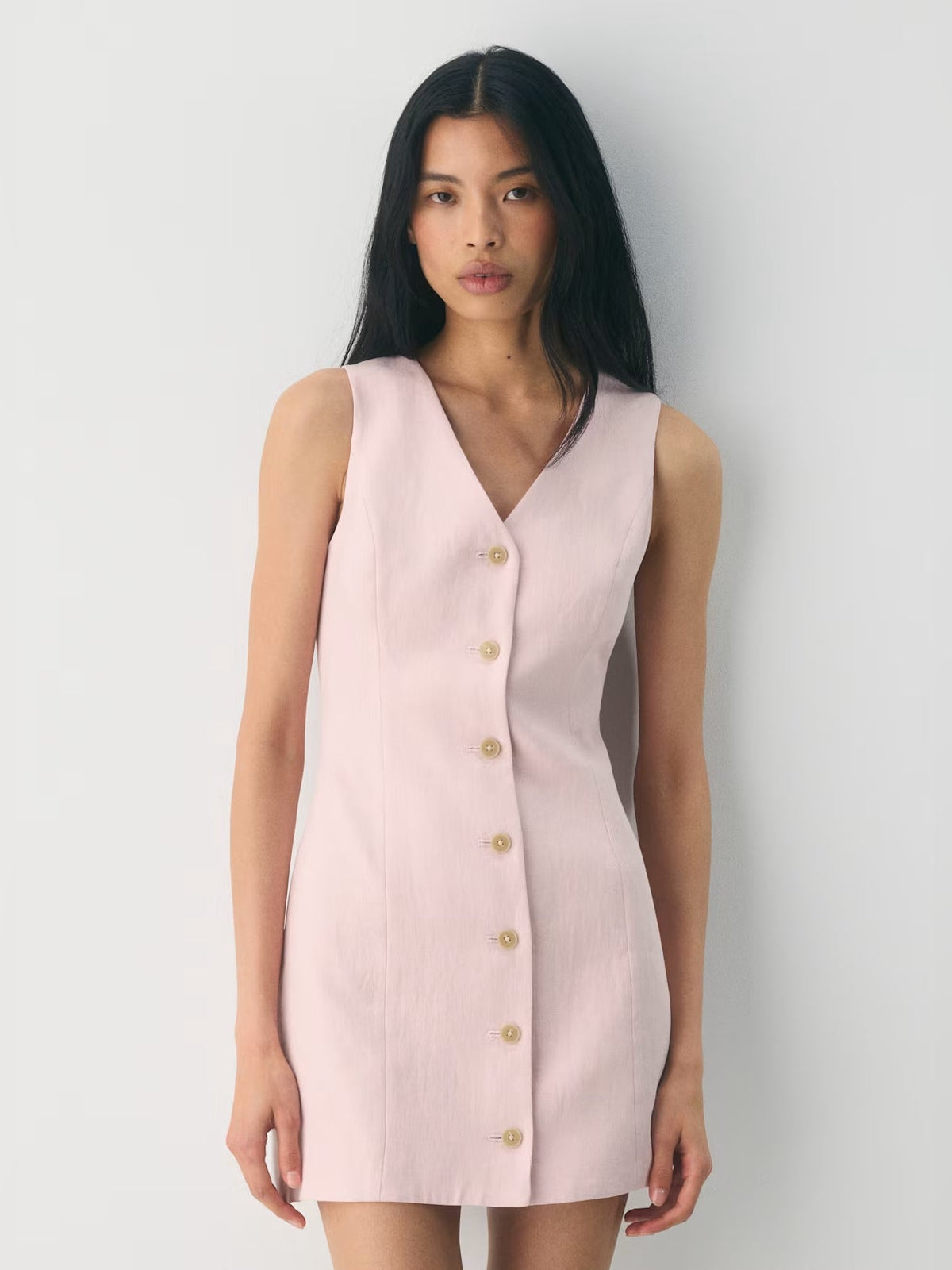Light pink V-neck sleeveless mini dress with front button details