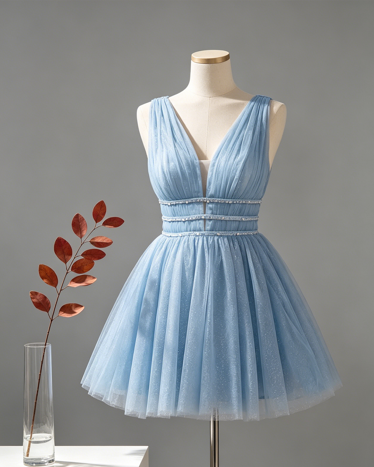 Light blue glitter tulle homecoming dress on mannequin, V-neck and beaded waist