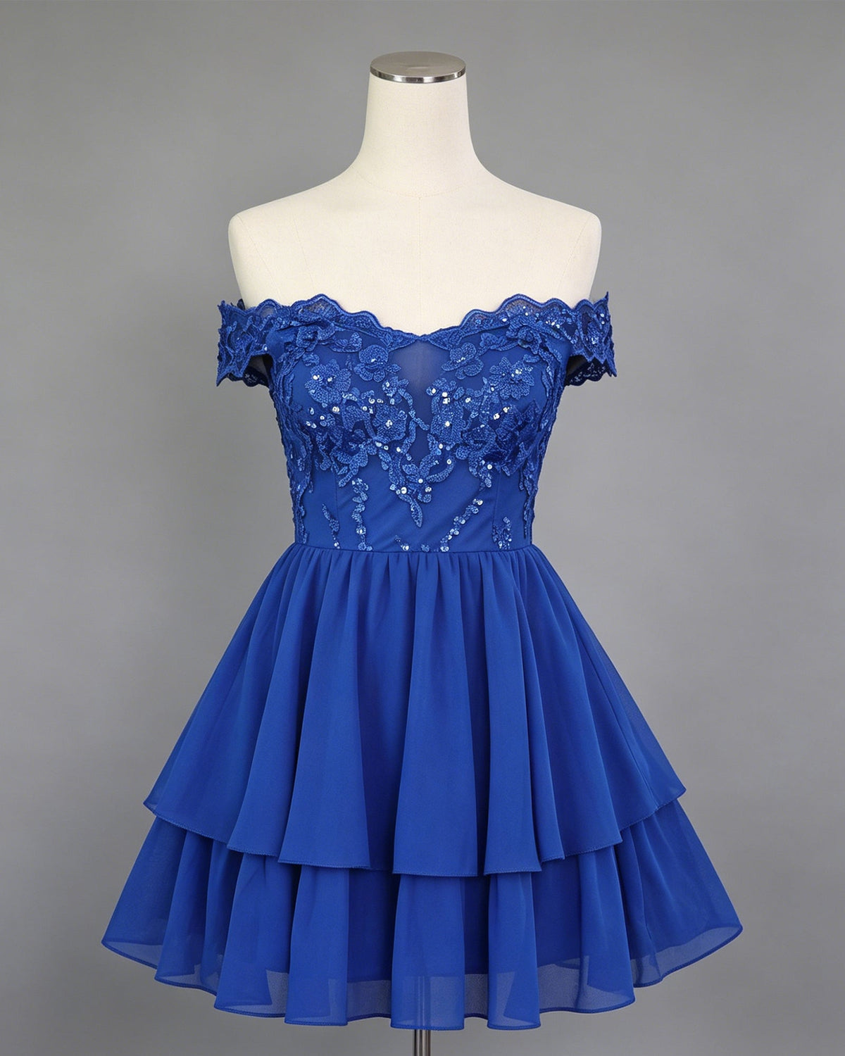 Royal blue off-shoulder lace A-line homecoming dress on mannequin with tiered skirt and bodice detail