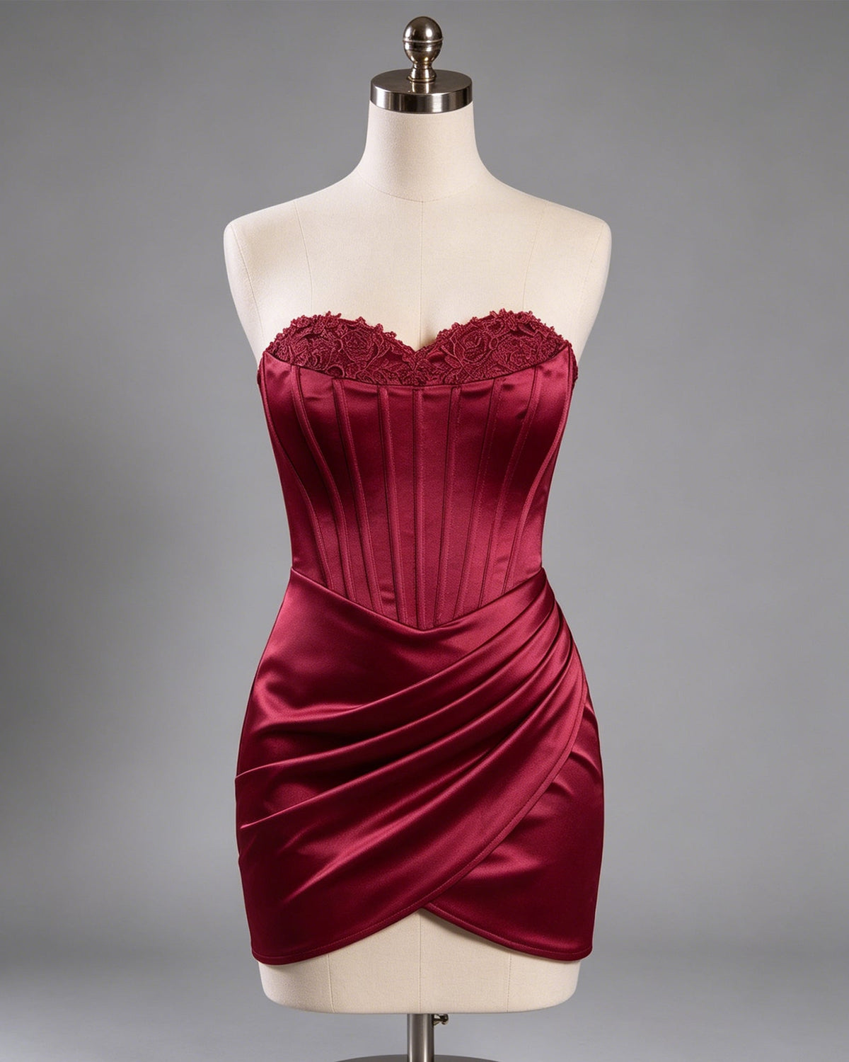 Burgundy satin mini dress on mannequin with lace-trim sweetheart top and wrap hem