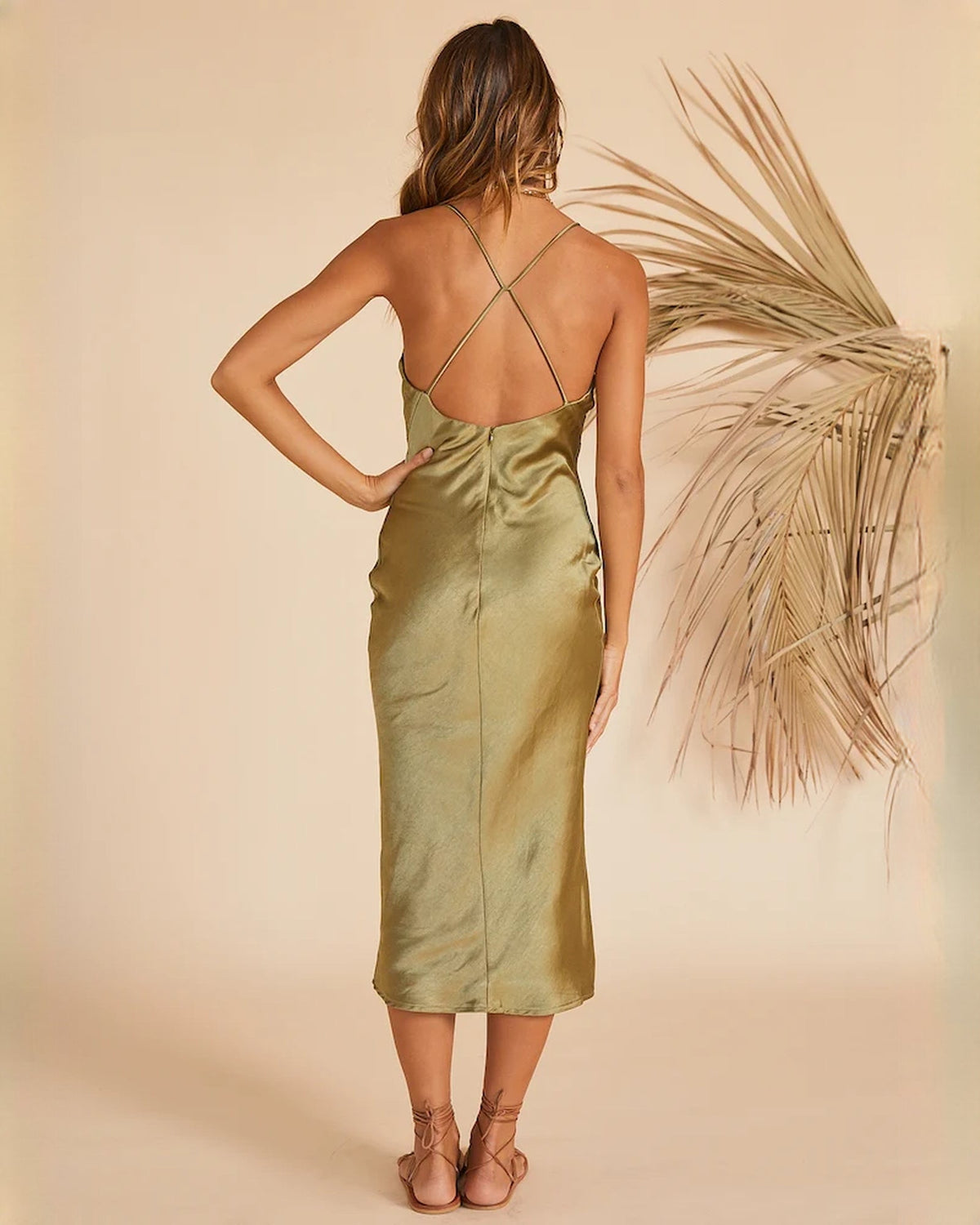 Sage green satin backless midi dress with crisscross straps and slim A-line fit
