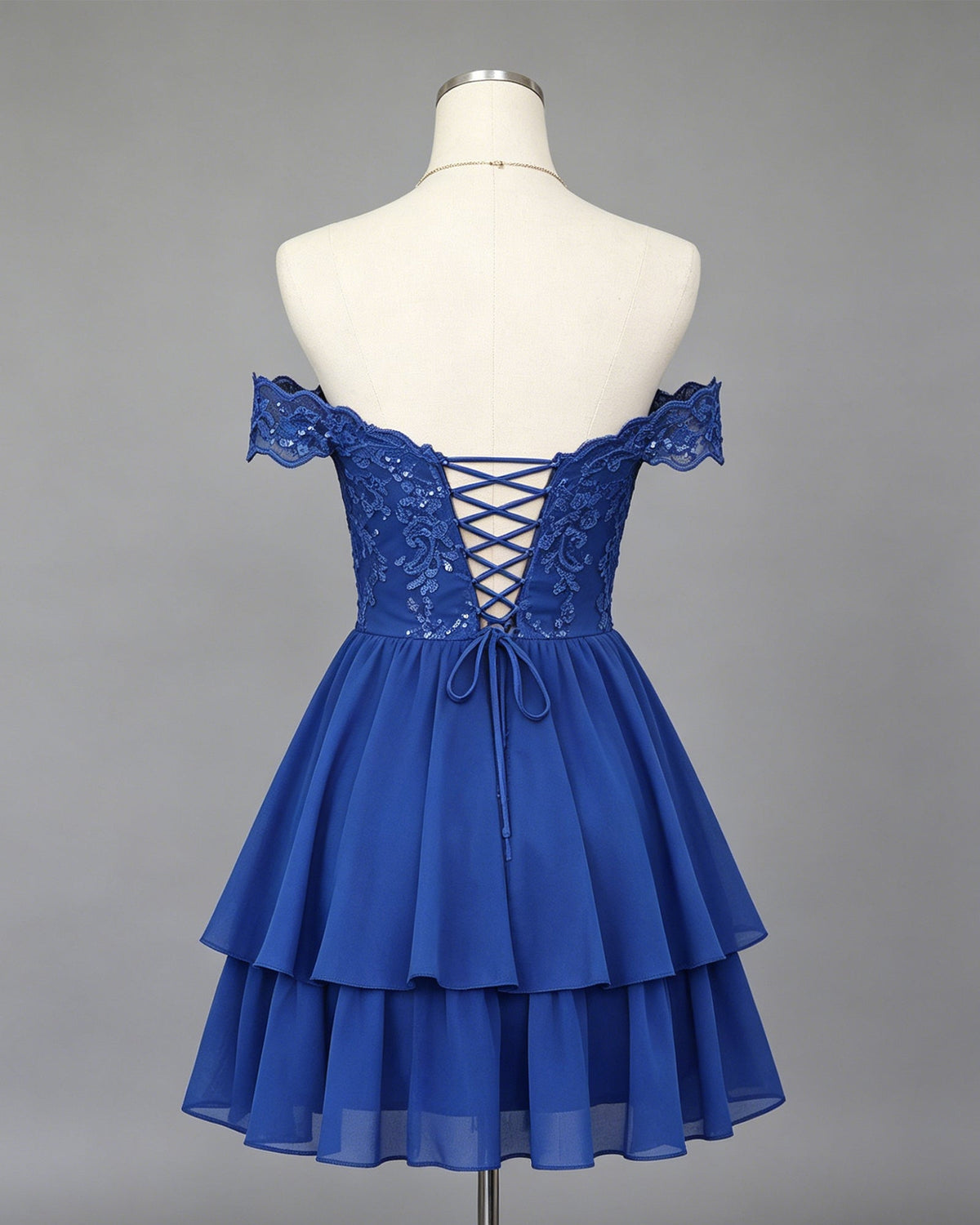 Royal blue off-shoulder lace homecoming dress on mannequin, lace-up open back, tiered A-line skirt