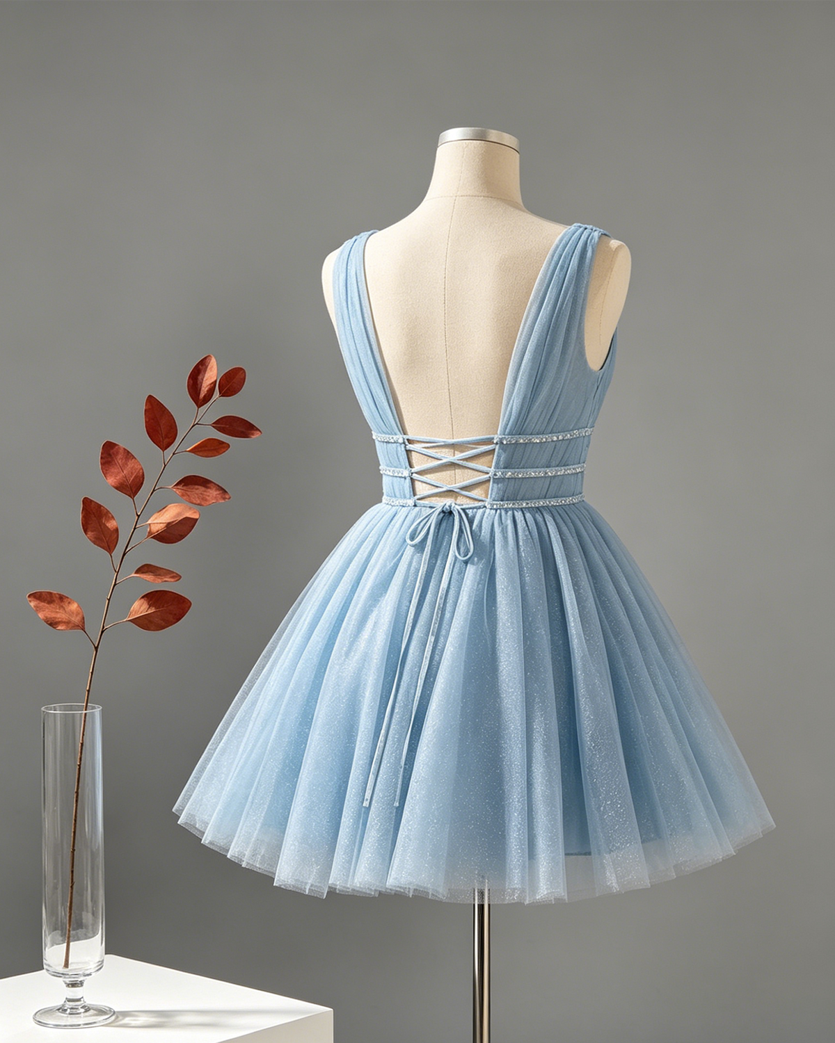 Light blue tulle homecoming dress back with crisscross straps and beaded waist