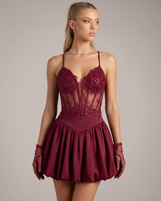 Burgundy lace corset homecoming dress with spaghetti straps and flared skirt
