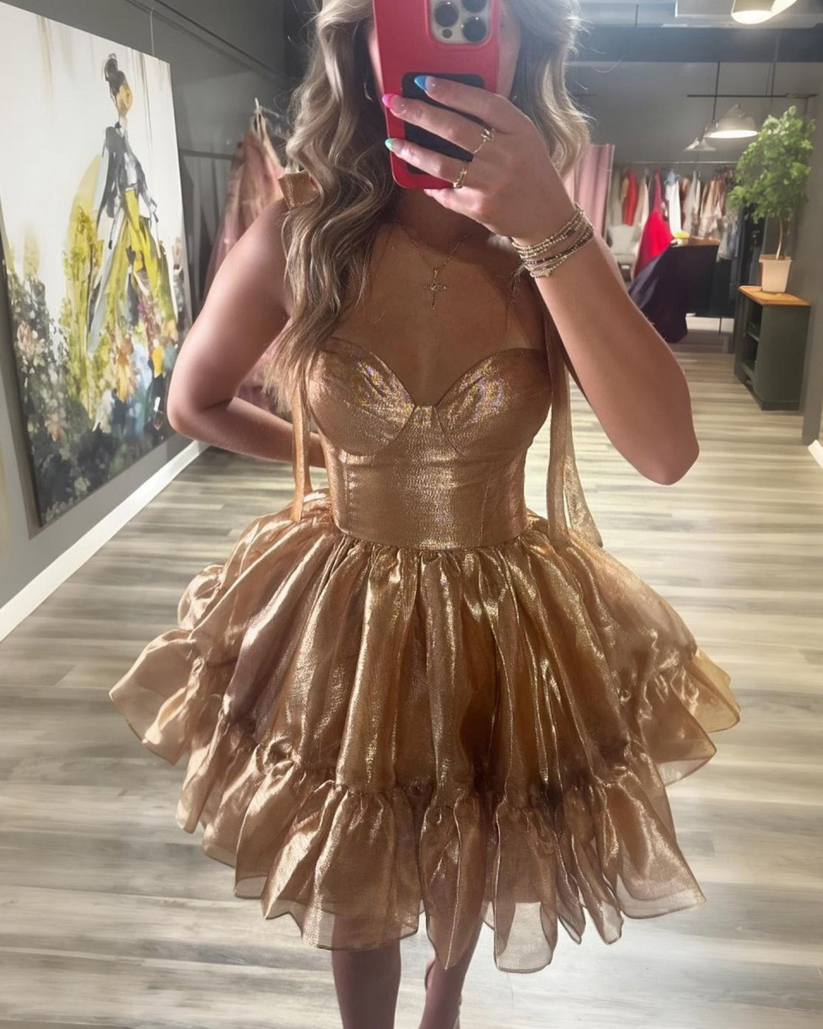 Champagne satin corset homecoming dress with bow shoulder straps and flared ruffle skirt