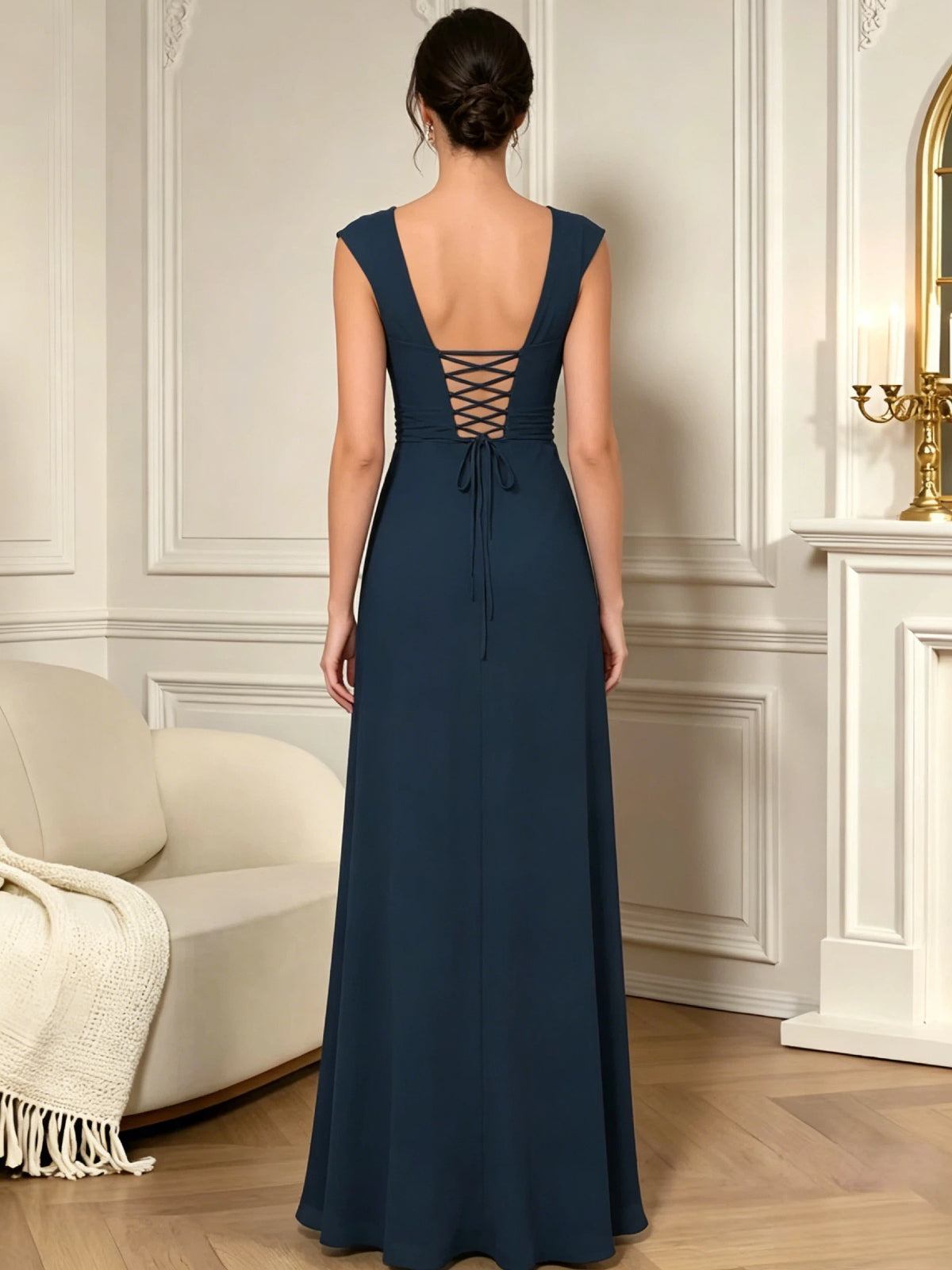 long sleeveless V-neck chiffon mother of the bride gown with pleated bodice and cascading ruffle detail shown on model in a formal wedding guest styling